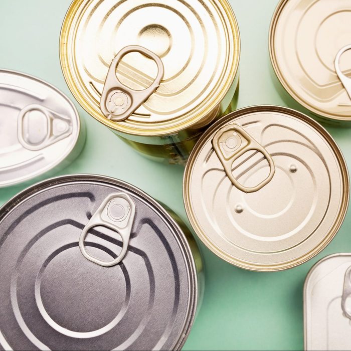 Directly above shot of canned food on turquoise background