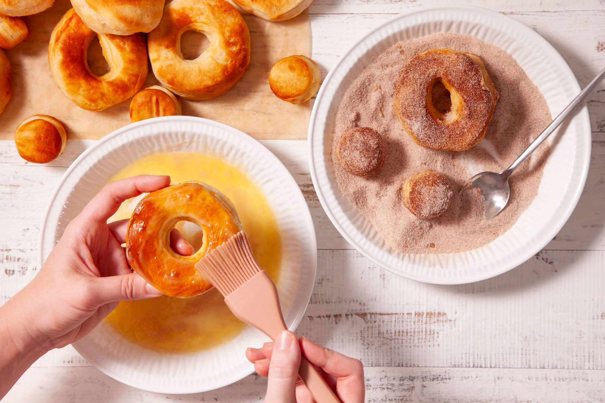 Applying Melted Butter on Air Fryer Doughnuts with Brush and Coating Them With Sugar