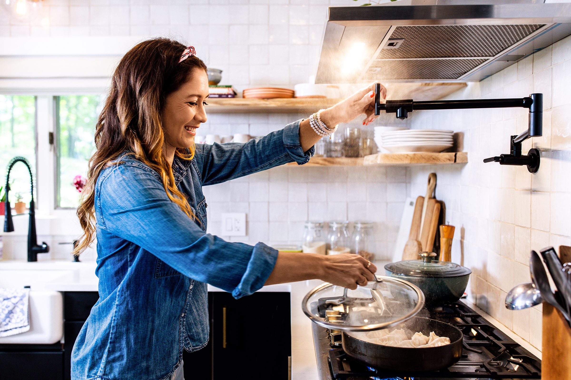 Peloton instuctor Emma Lovewell cooking dumplings in her kitchen