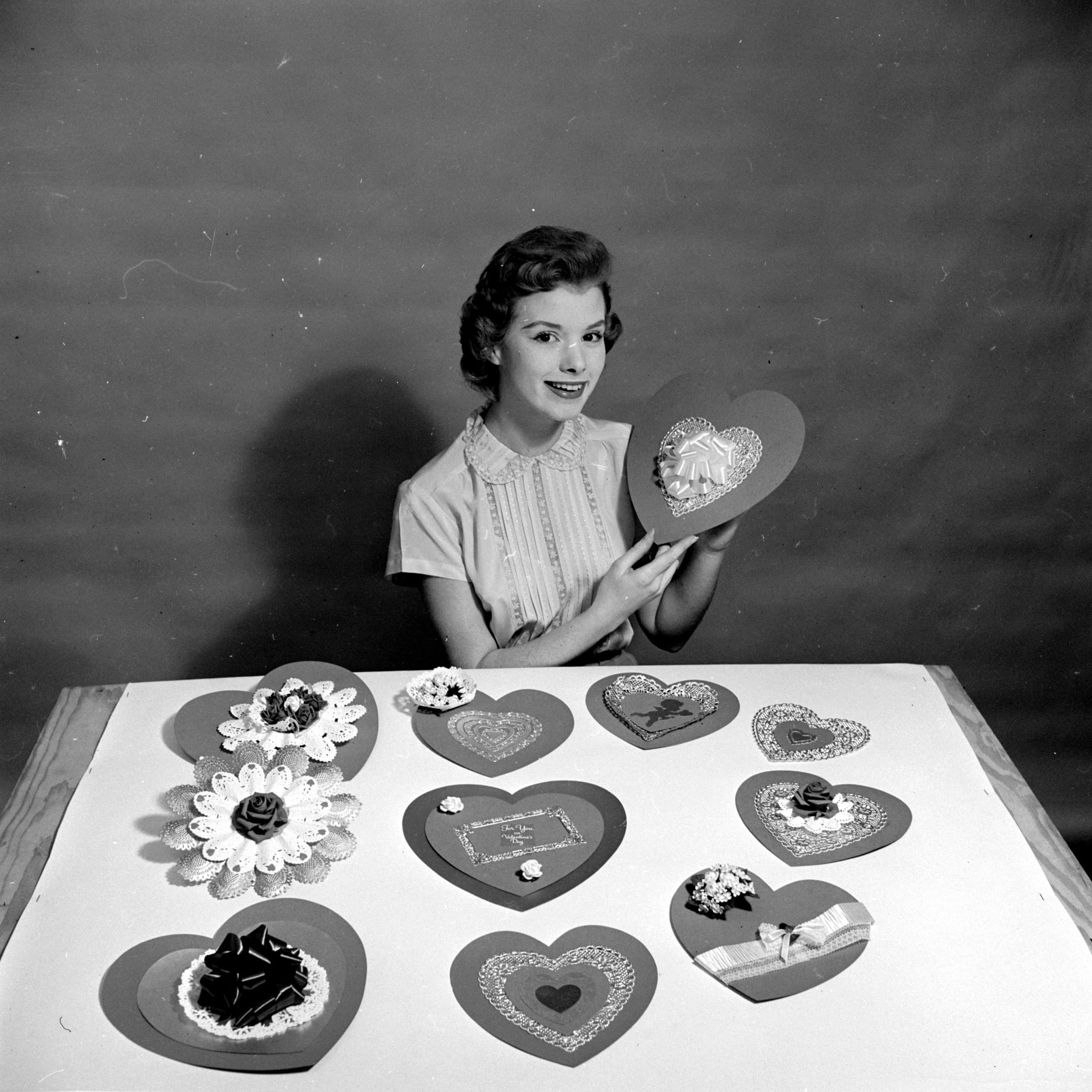 A woman making heart-shaped home-made cards for her sweethearts on Saint Valentine
