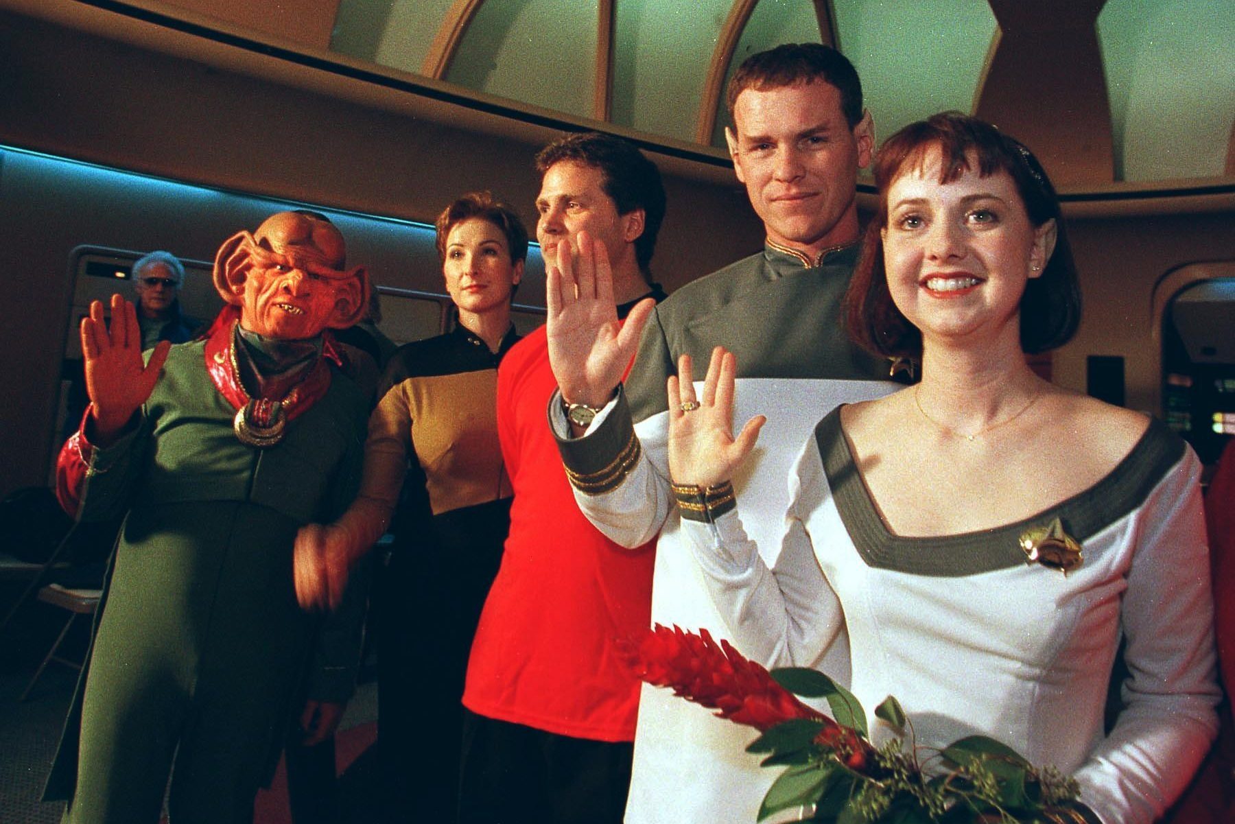 Joined by Ferengis, Klingons and Starfleet crew members, Star Trek fans Mikel (R) and Craig Salsgiver (2nd R) display the Vulcan greeting after renewing their vows on Valentine