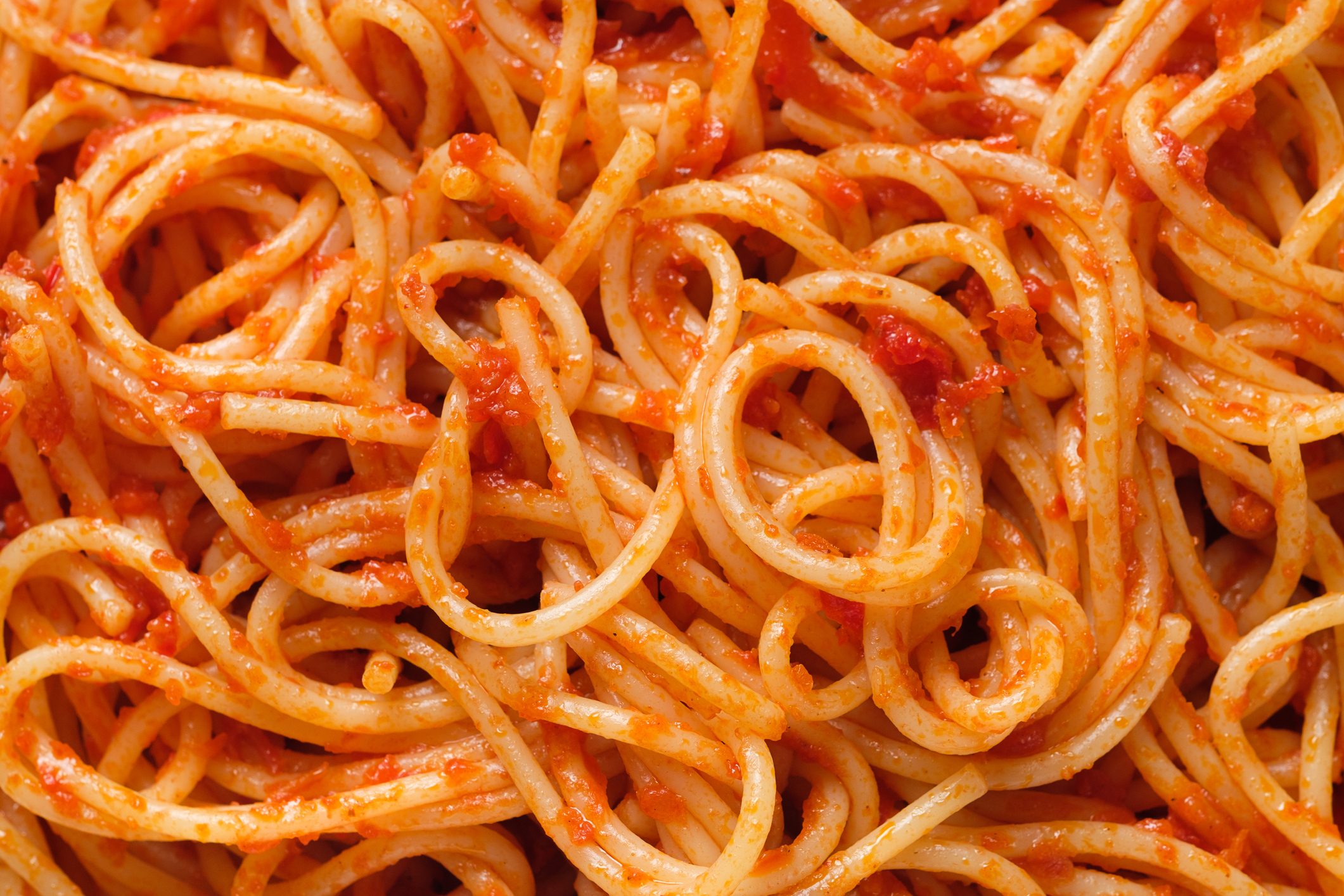 Spaghetti or pasta bolognese in tomato sauce on a ceramic plate, on a white background or table. The concept of Vegetarian and Vegan Food. Food background.