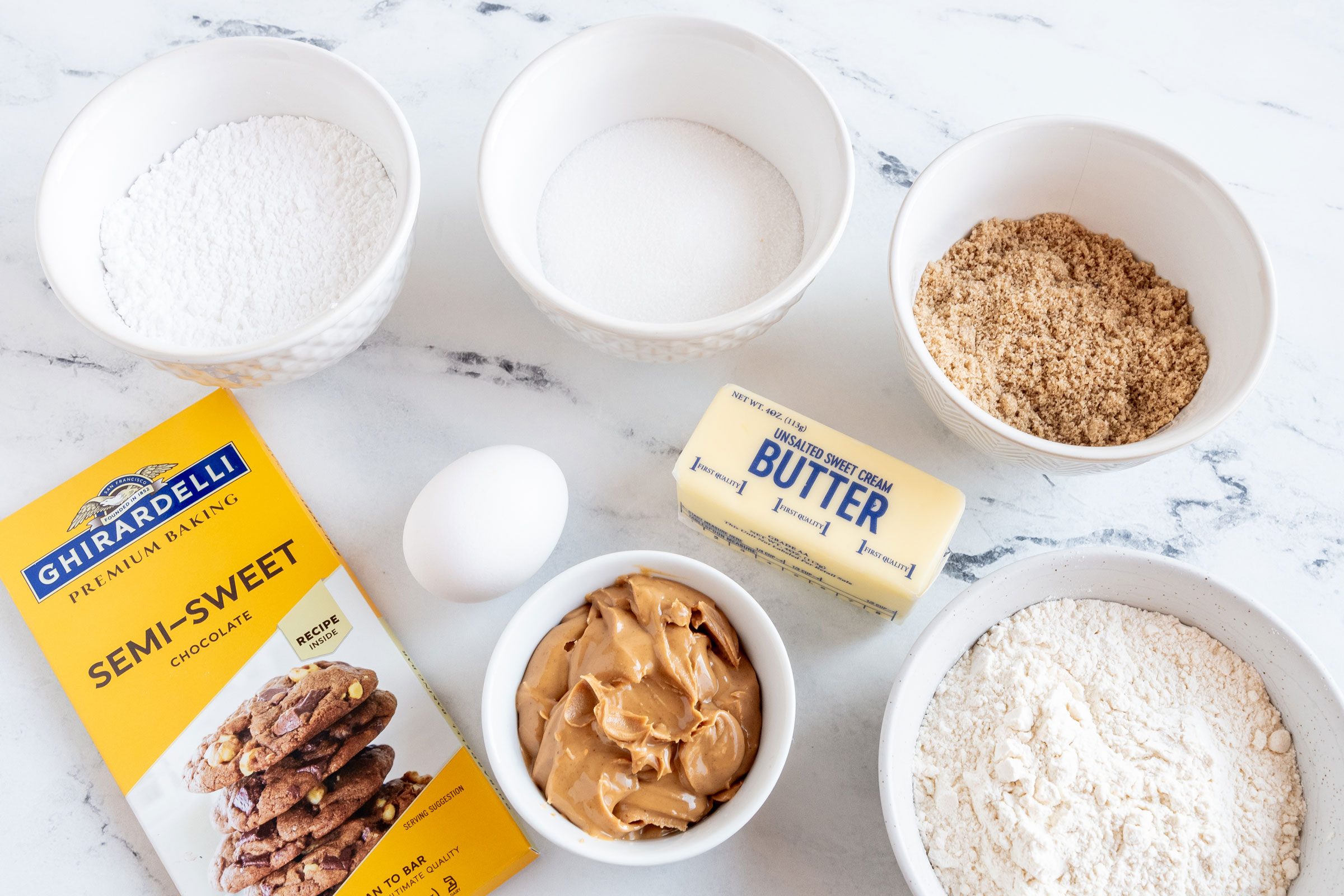 Tagalongs ingredients laid out on a marble kitchen counter