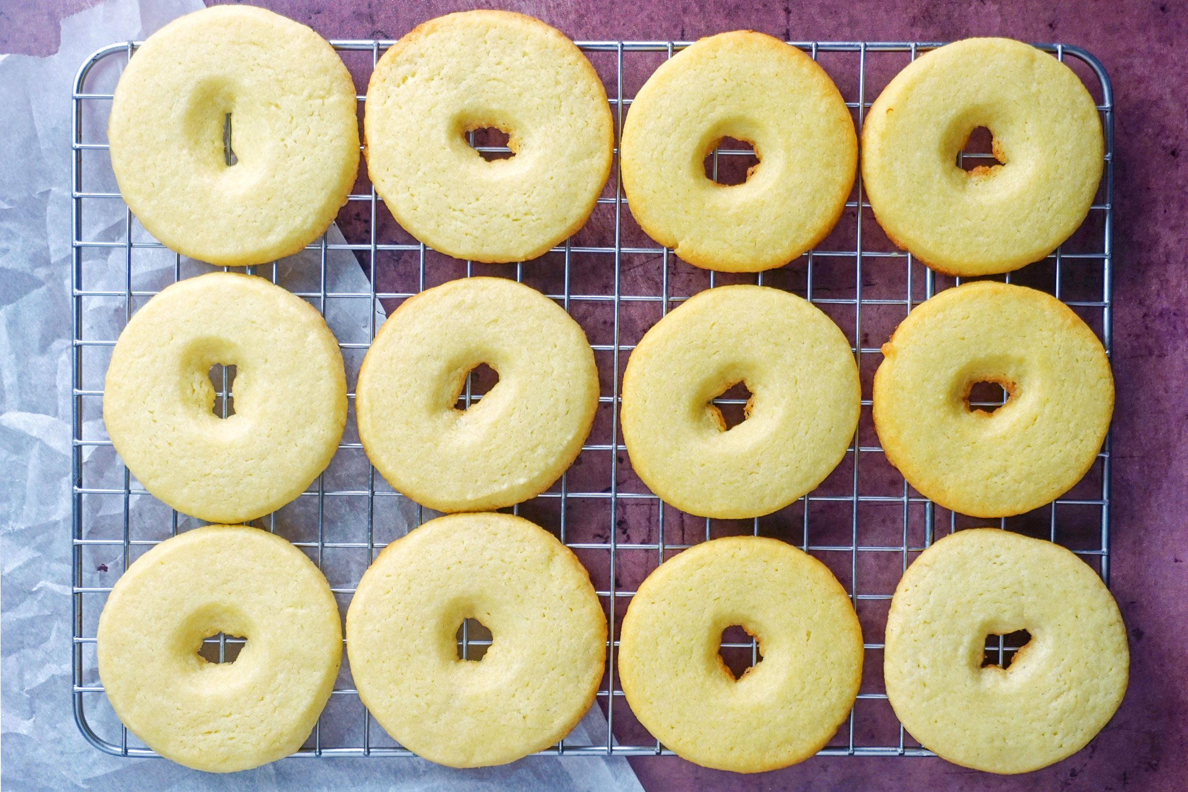 baked cookies cooling on a wire cooling rack on purple background