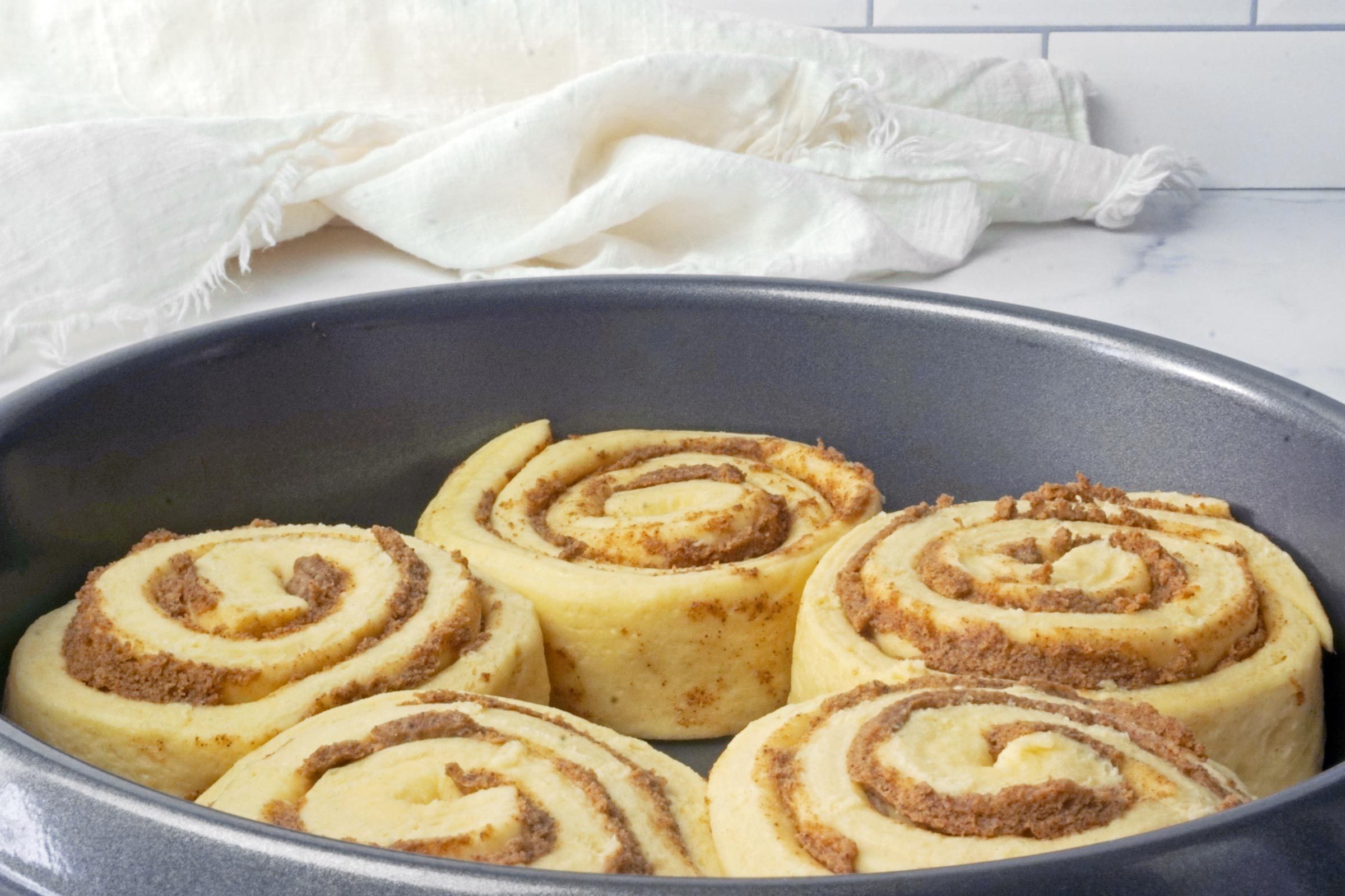 unbaked TikTok cinnamon rolls In a pan