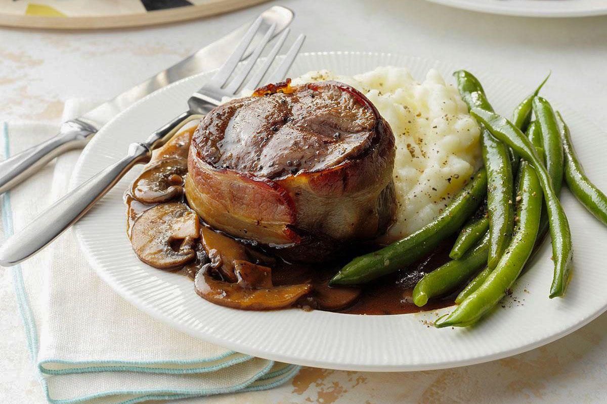 Air Fryer Bacon Wrapped Filets served on plate with beans