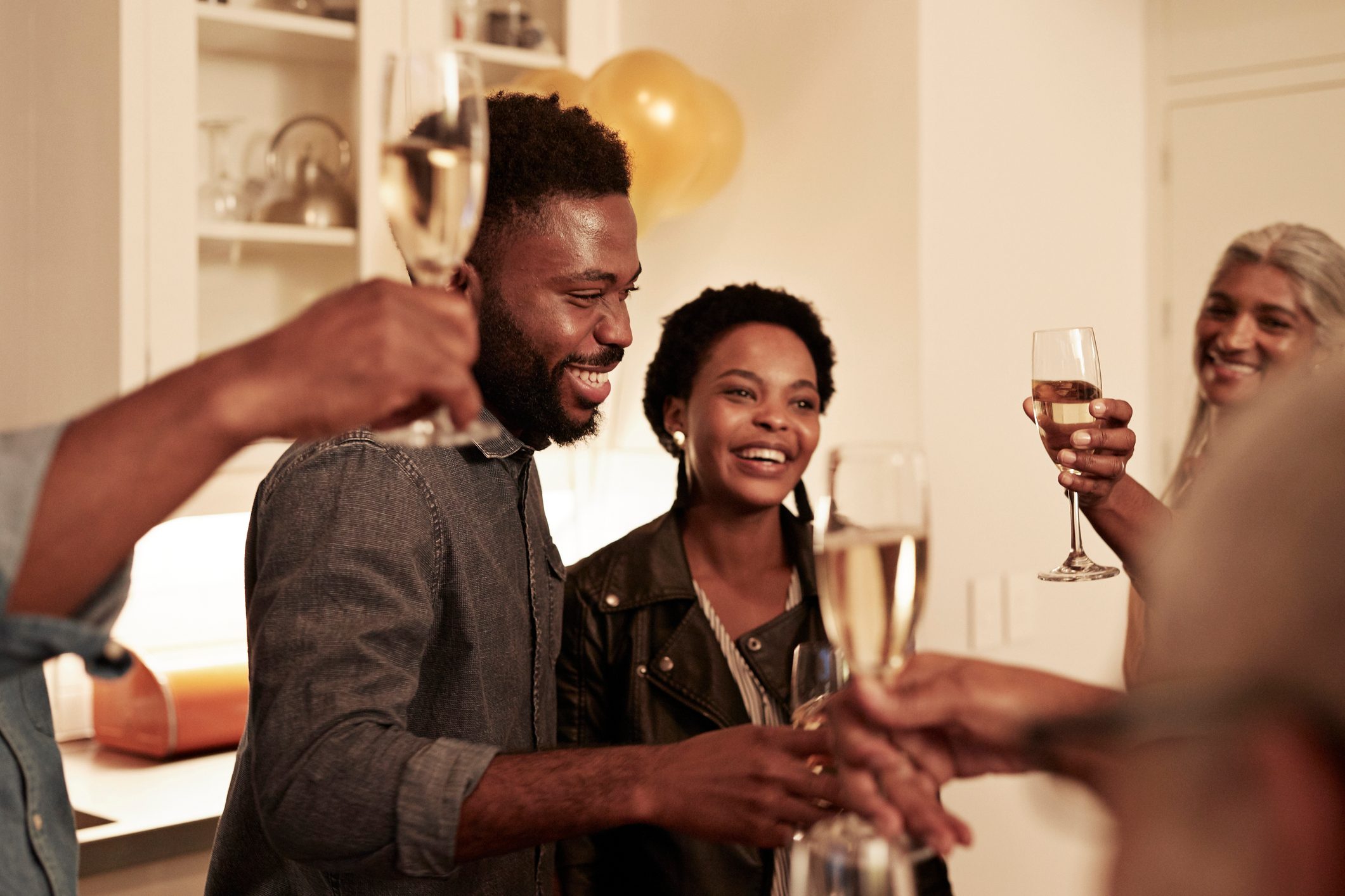 Smiling family enjoying drinks at birthday party