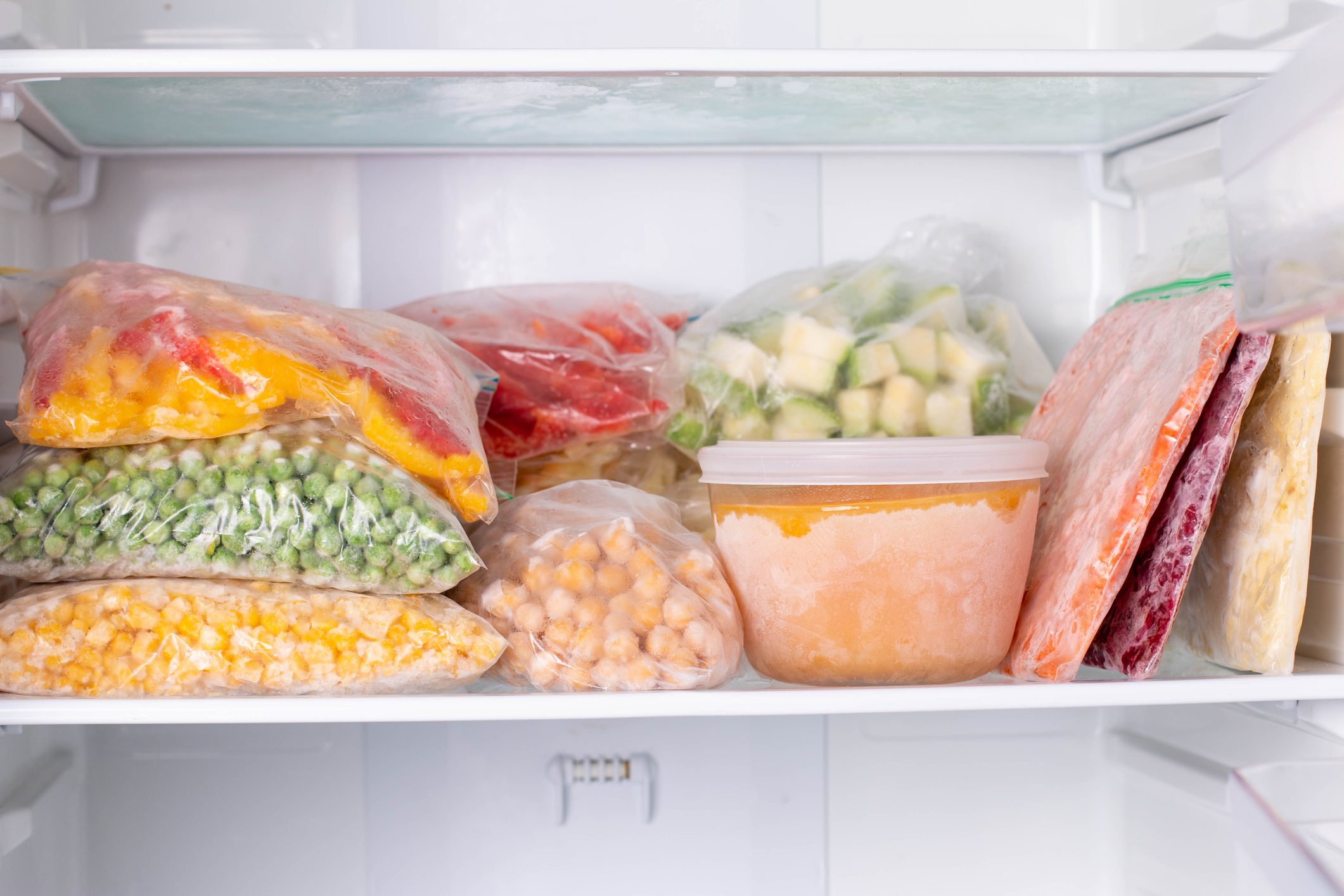 Frozen food in the freezer. Frozen vegetables, soup, ready meals