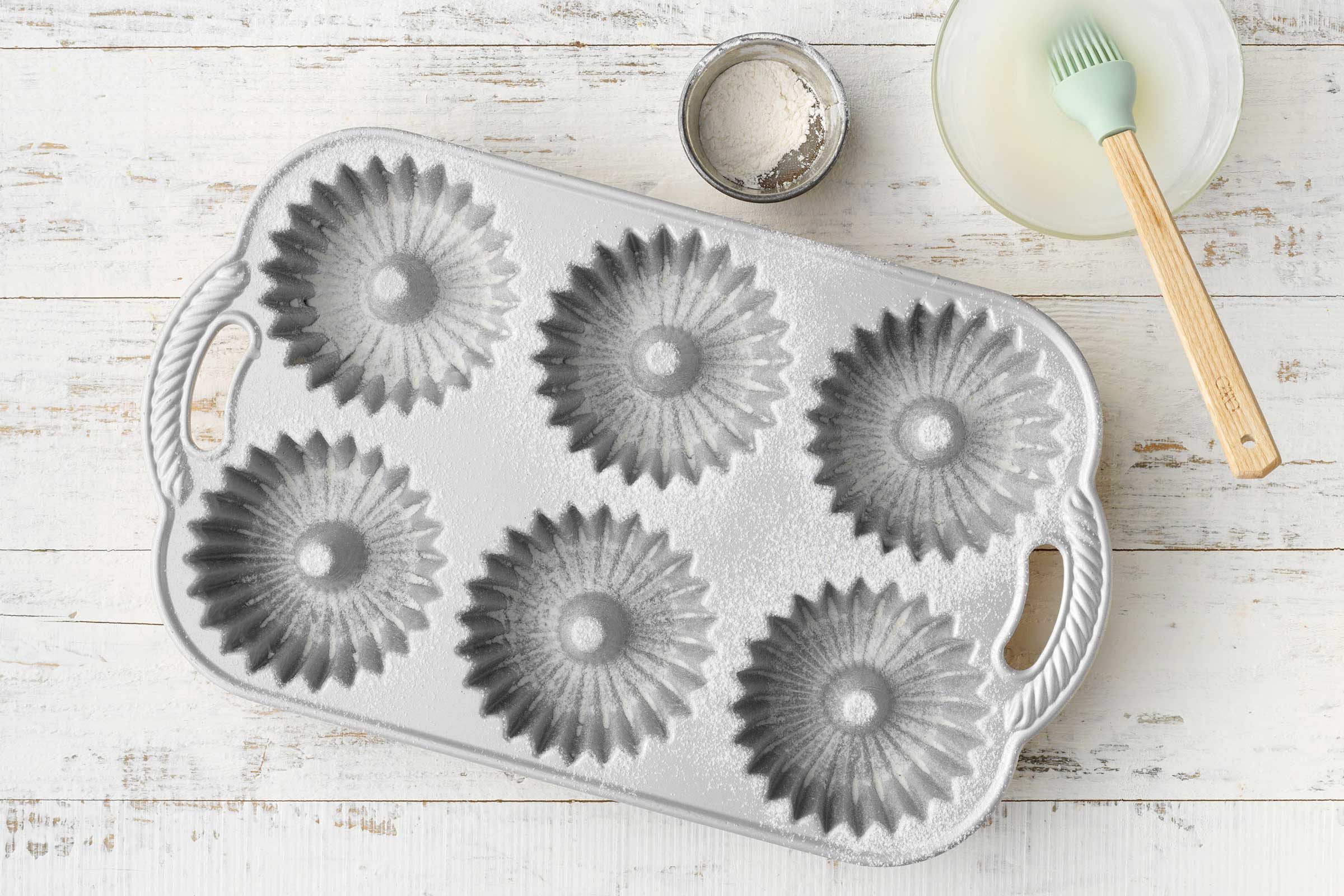 Little Lemon Pound Cakes Showing greased fluted tubed pans.