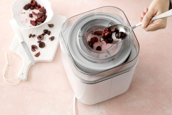 making cherry ice cream in an ice cream maker