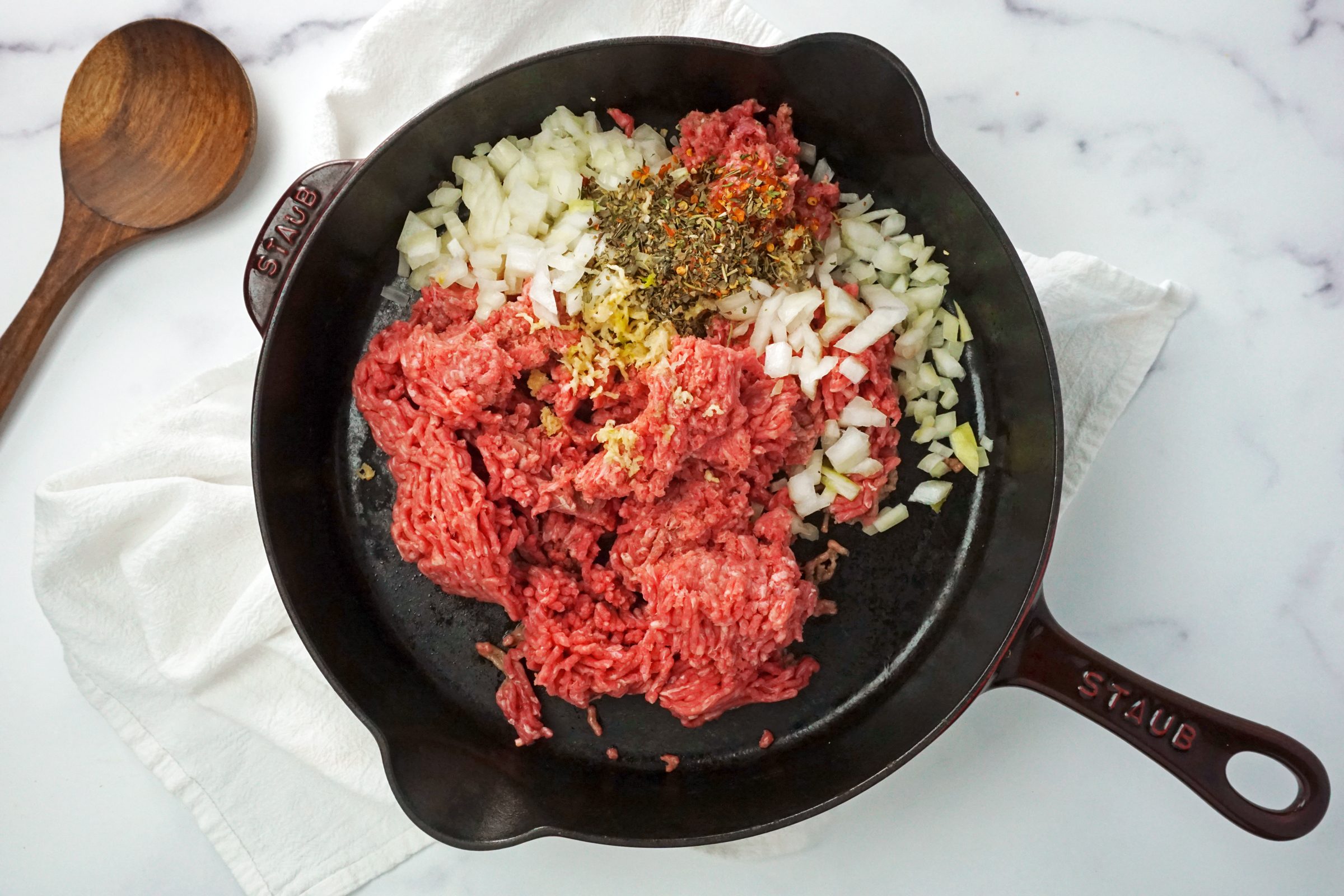 meat and spices in a cast iron skillet