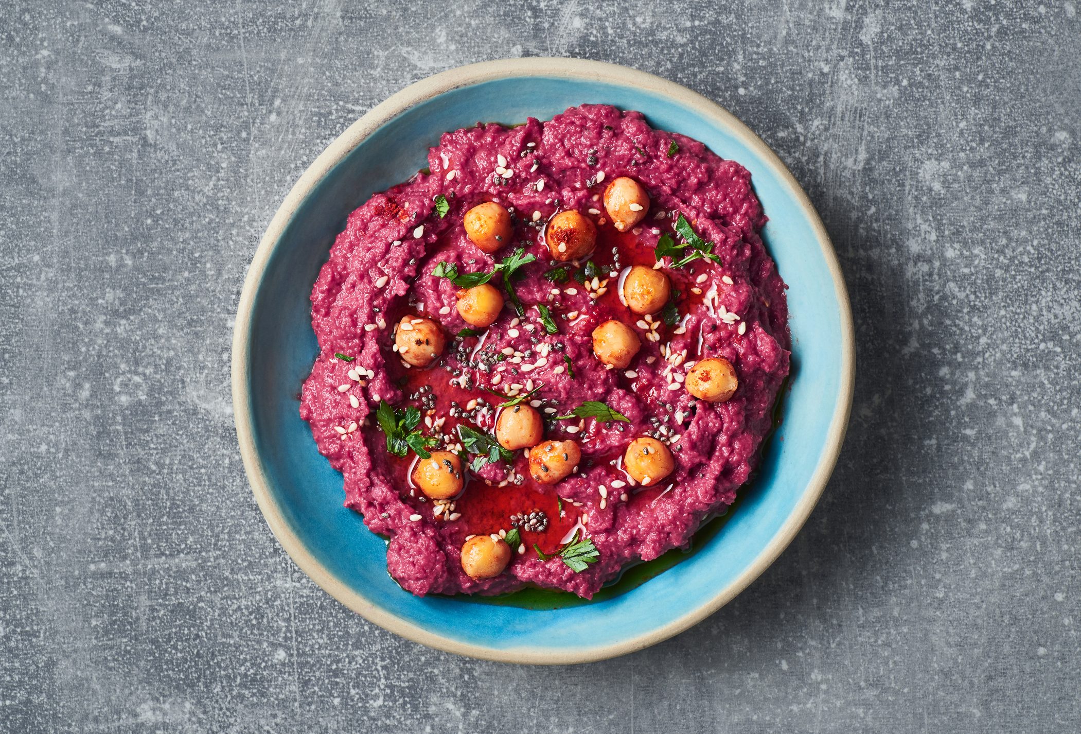 Vegan beetroot hummus with sesame seeds and chickpeas.