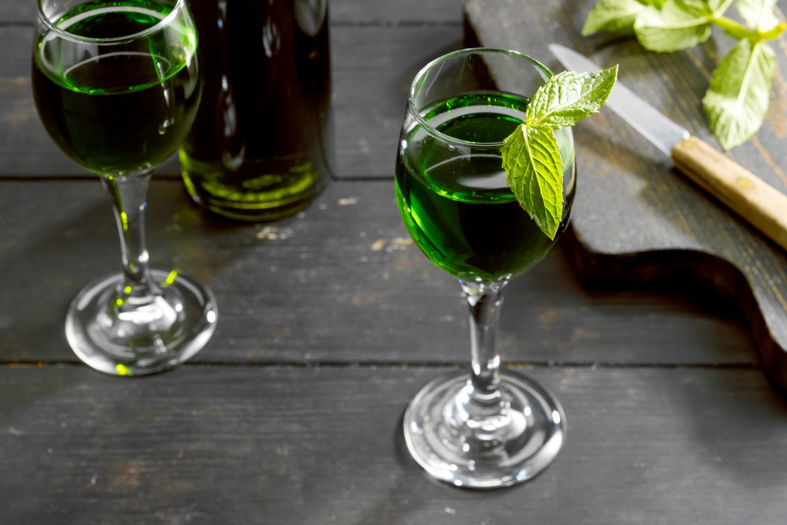 Homemade Creme De Menthe in Wine Glasses on Wooden Surface