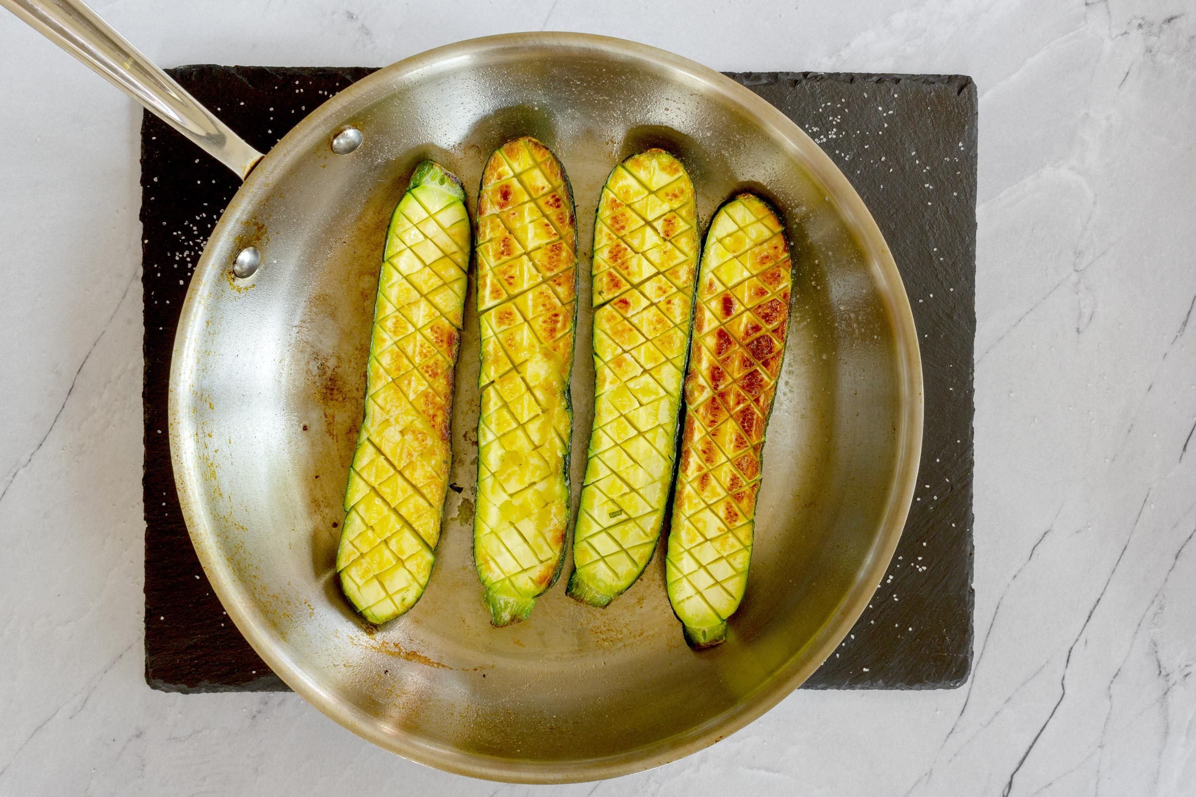 searing zucchini in a skillet