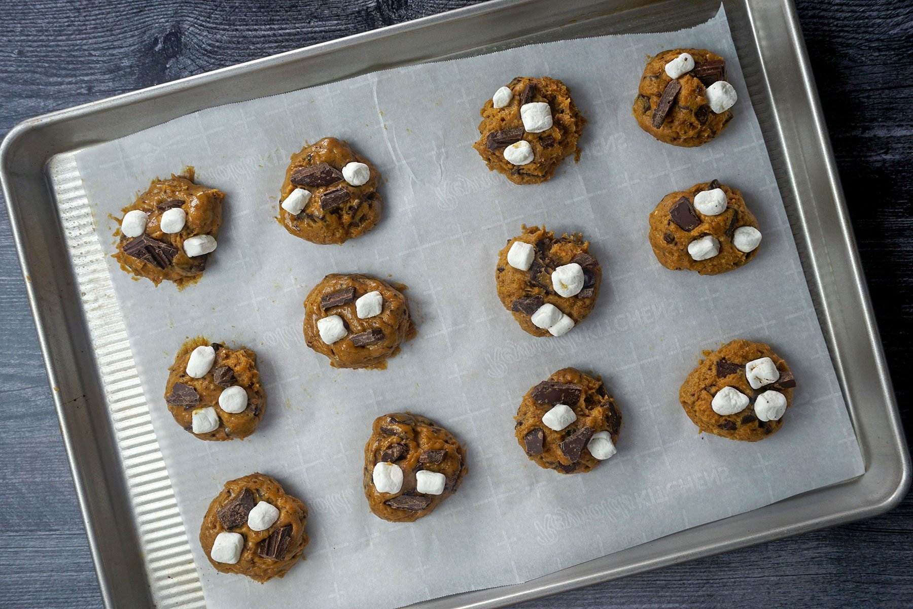 divided cookie dough balls on parchment paper 