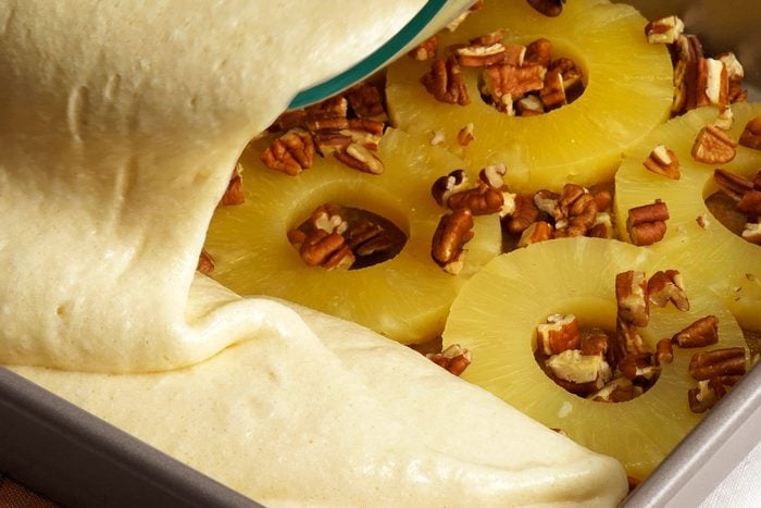 Pouring batter on Pineapples