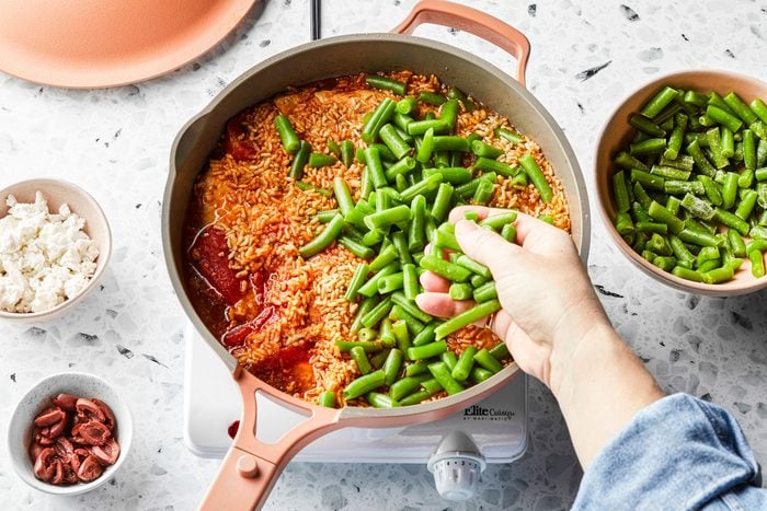 Beans rice and chicken mixed in a large pan