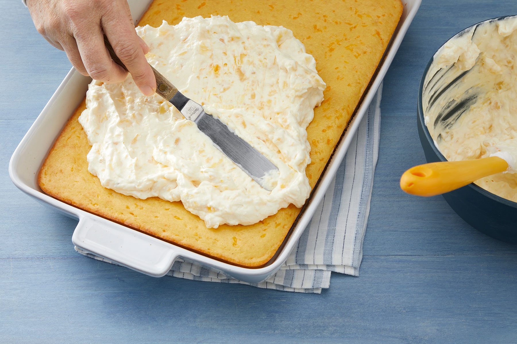 Spreading the topping on cake