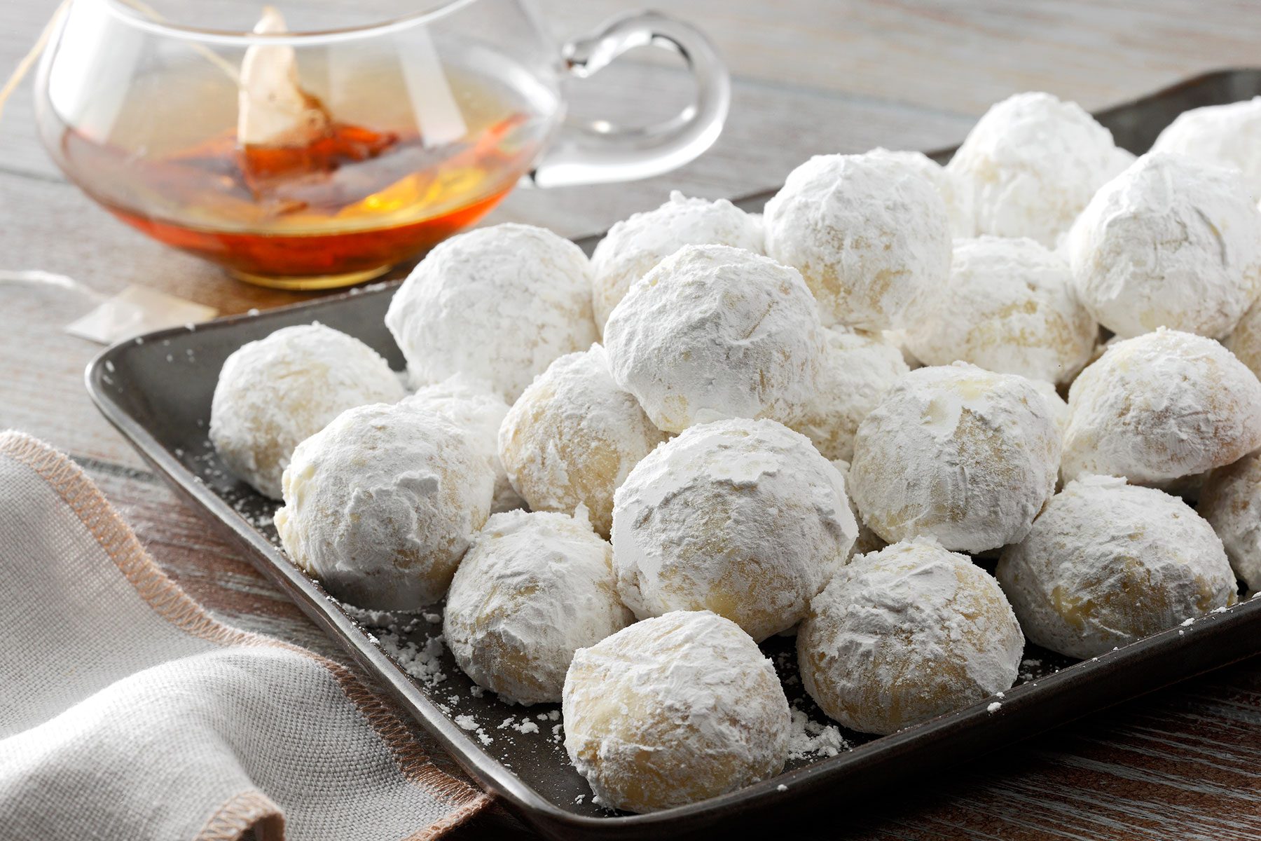Russian Tea Cakes on serving tray with tea
