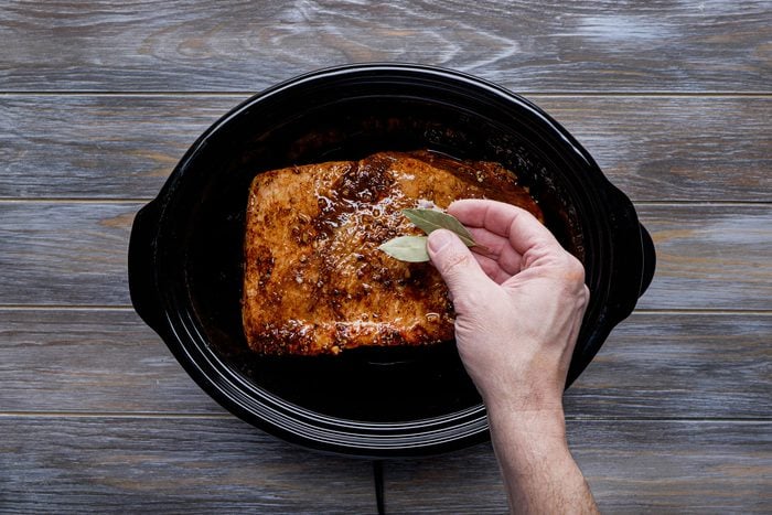 Slow cook the brisket with broth and bay leaves
