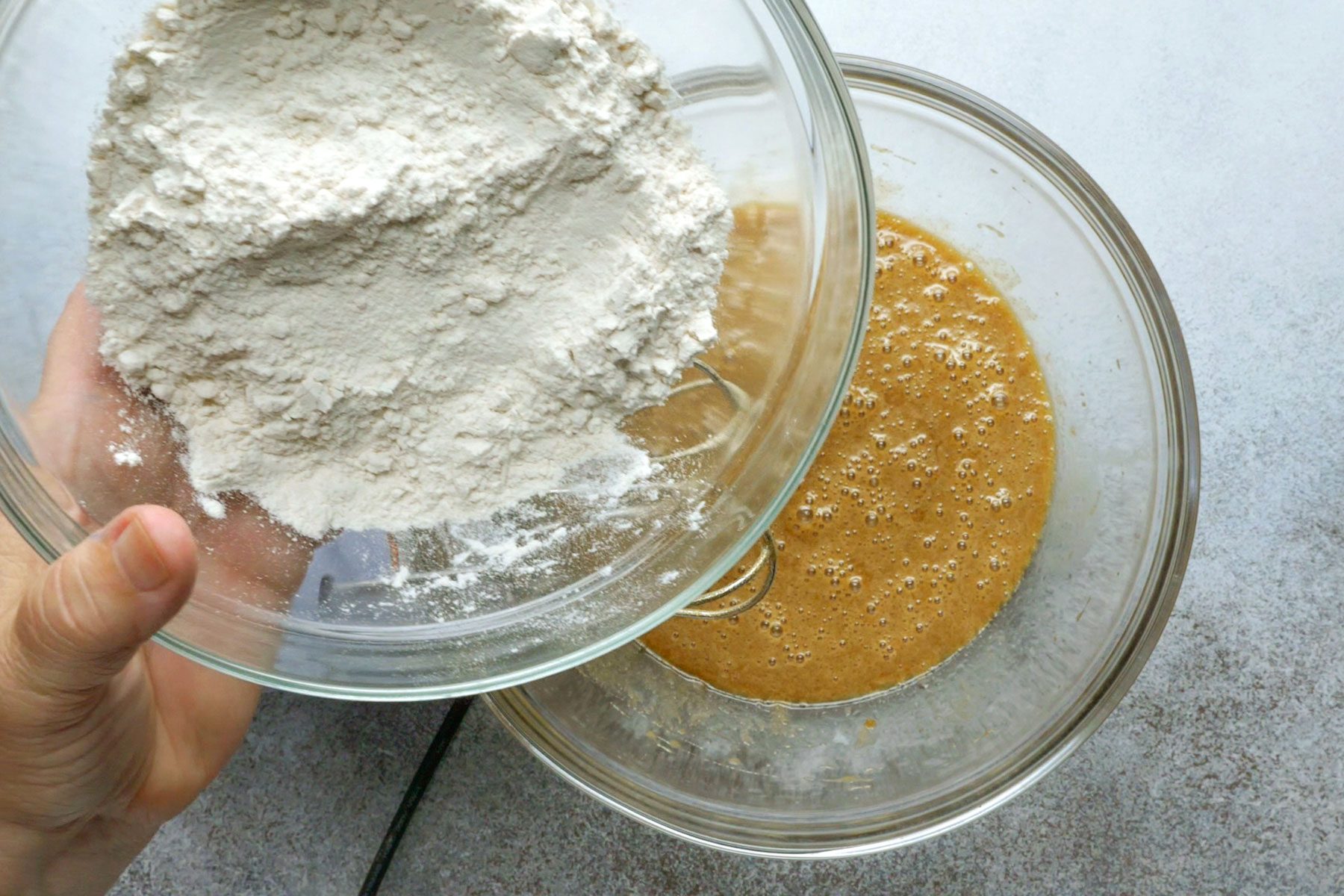 Mixing dry ingredients in a bowl with wet ingredients