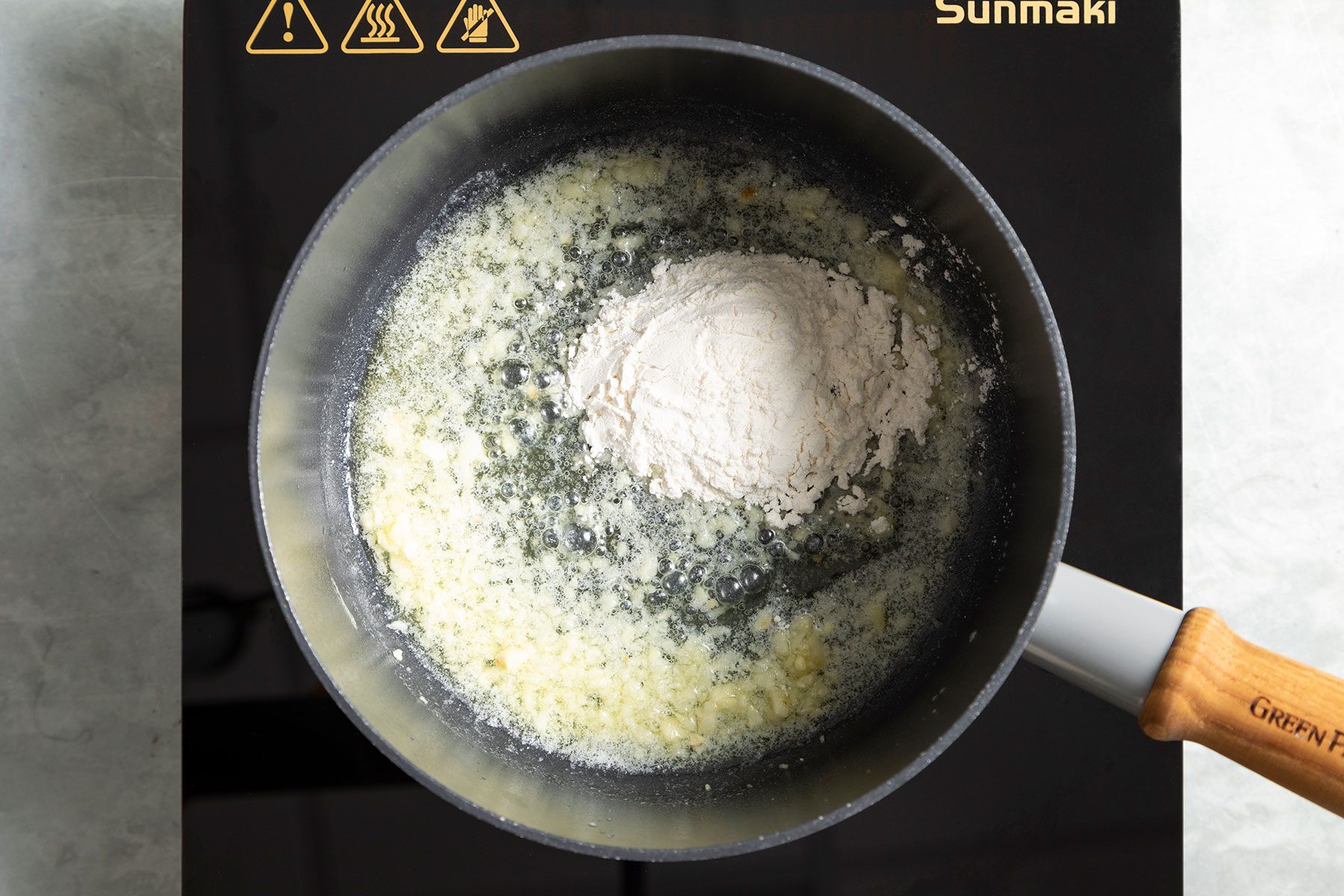 Mixing butter, flour and garlic in sauce pan