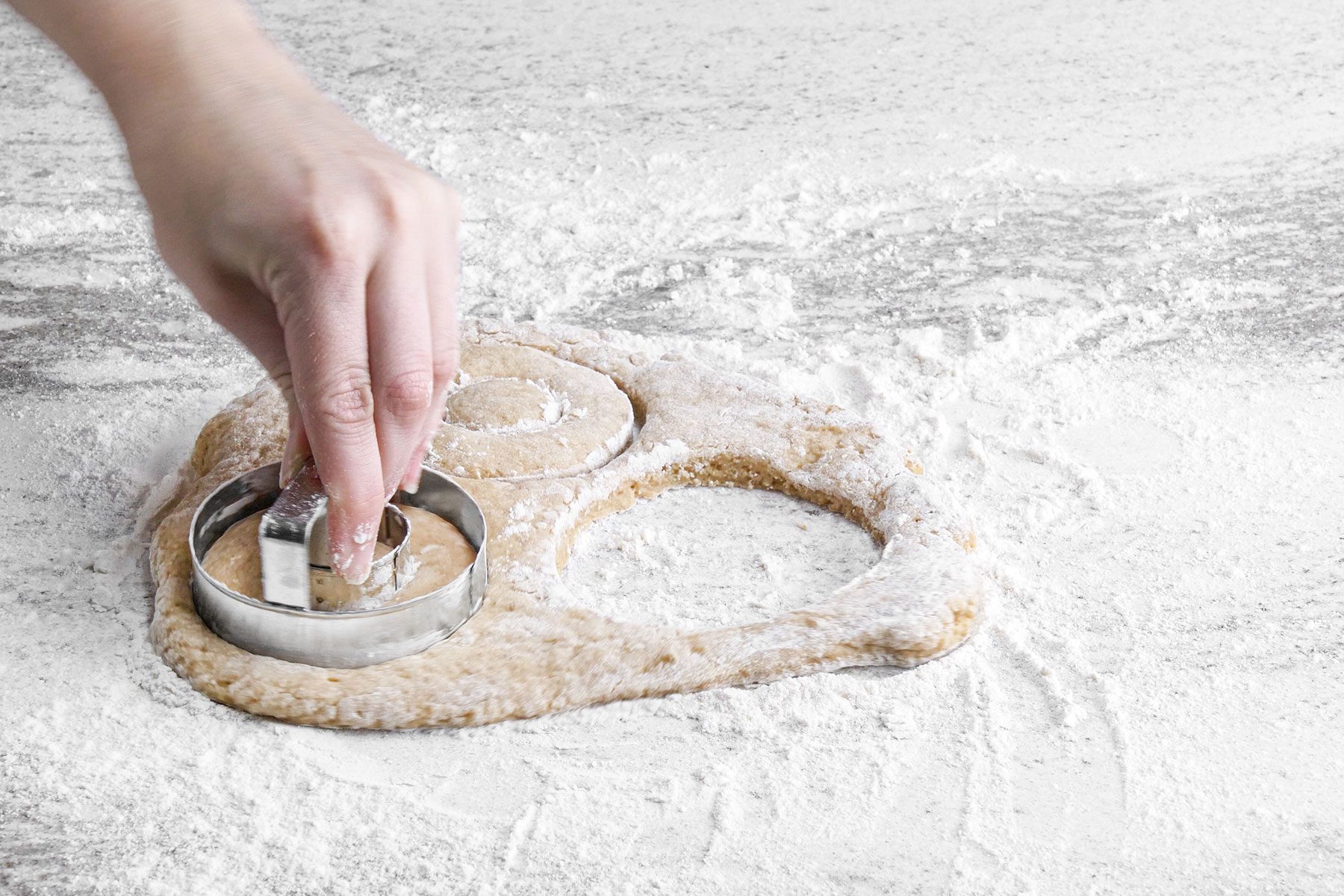 Cutting doughnuts with cutter 