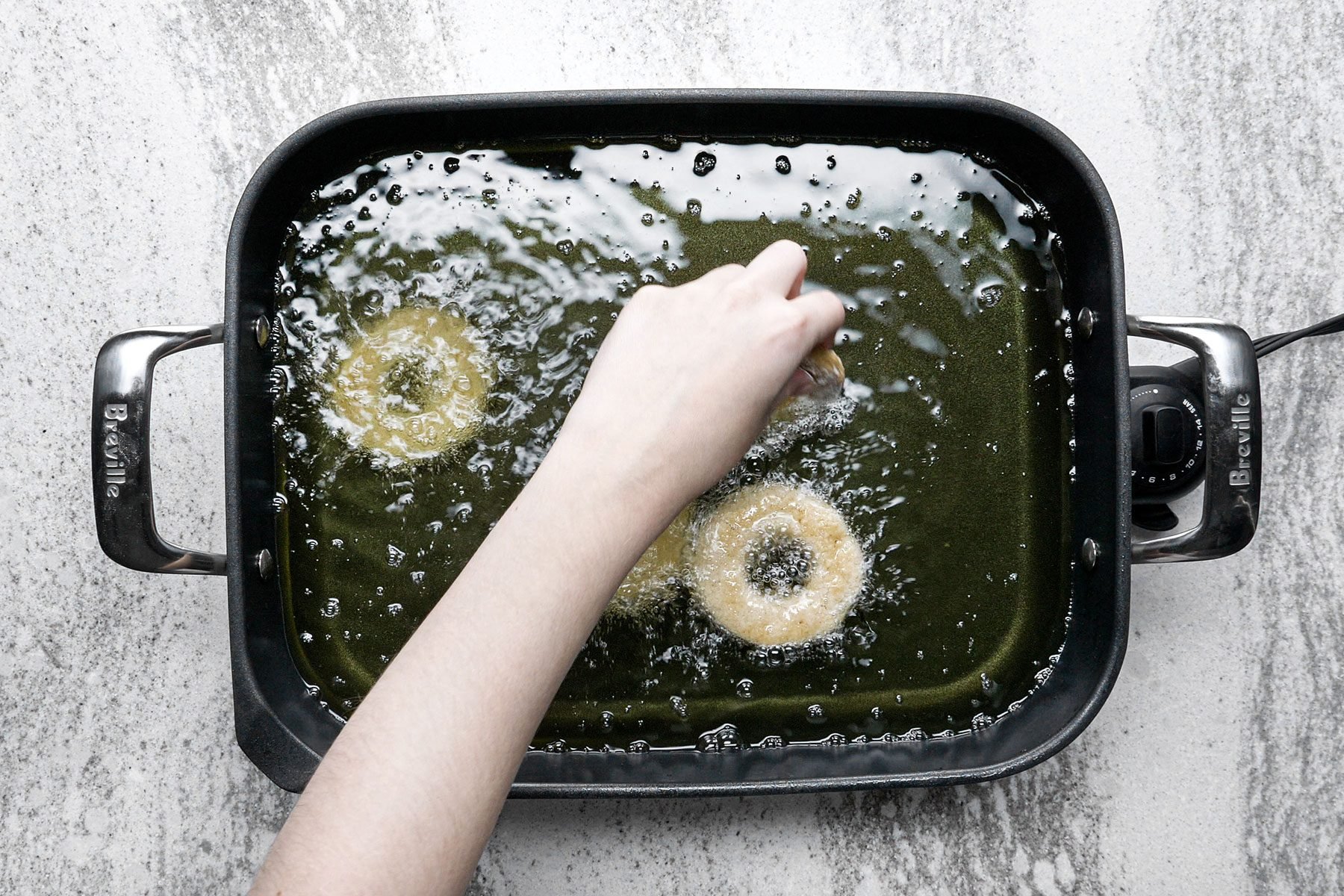 Frying the doughnuts in skillet