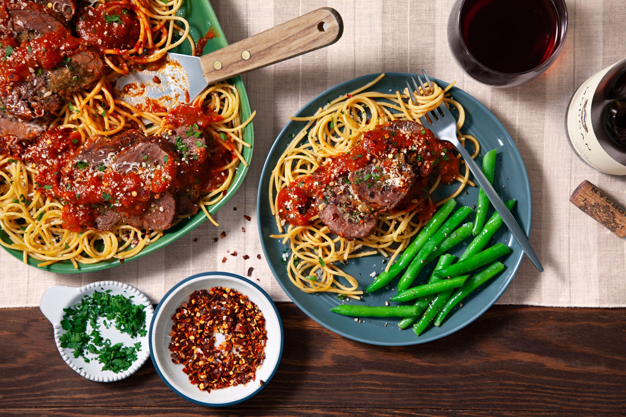 Braciole served with Parmesan cheese and minced fresh parsley in a plate