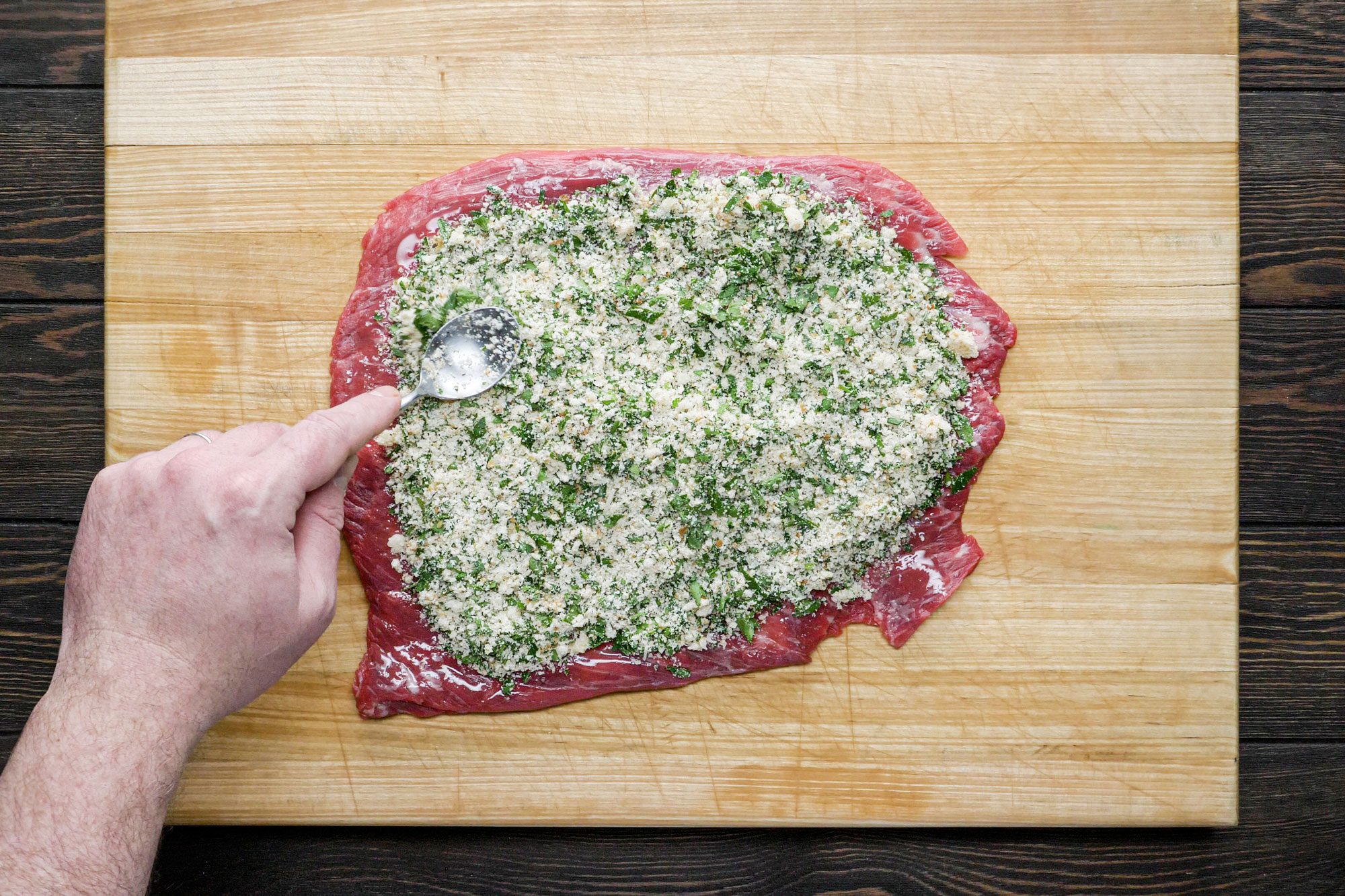 Spoon the stuffing over the beef and press down gently