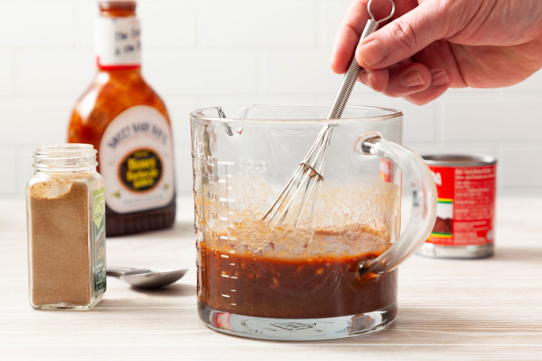 Peppers, adobo sauce, barbecue sauce mixed together in a jar