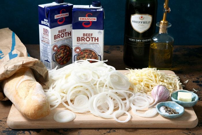 Onion cheese bread and other ingredients on a wooden tray.
