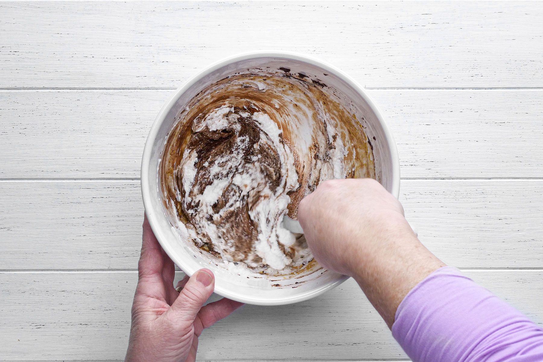 Folding chocolate mixture in beaten egg whites