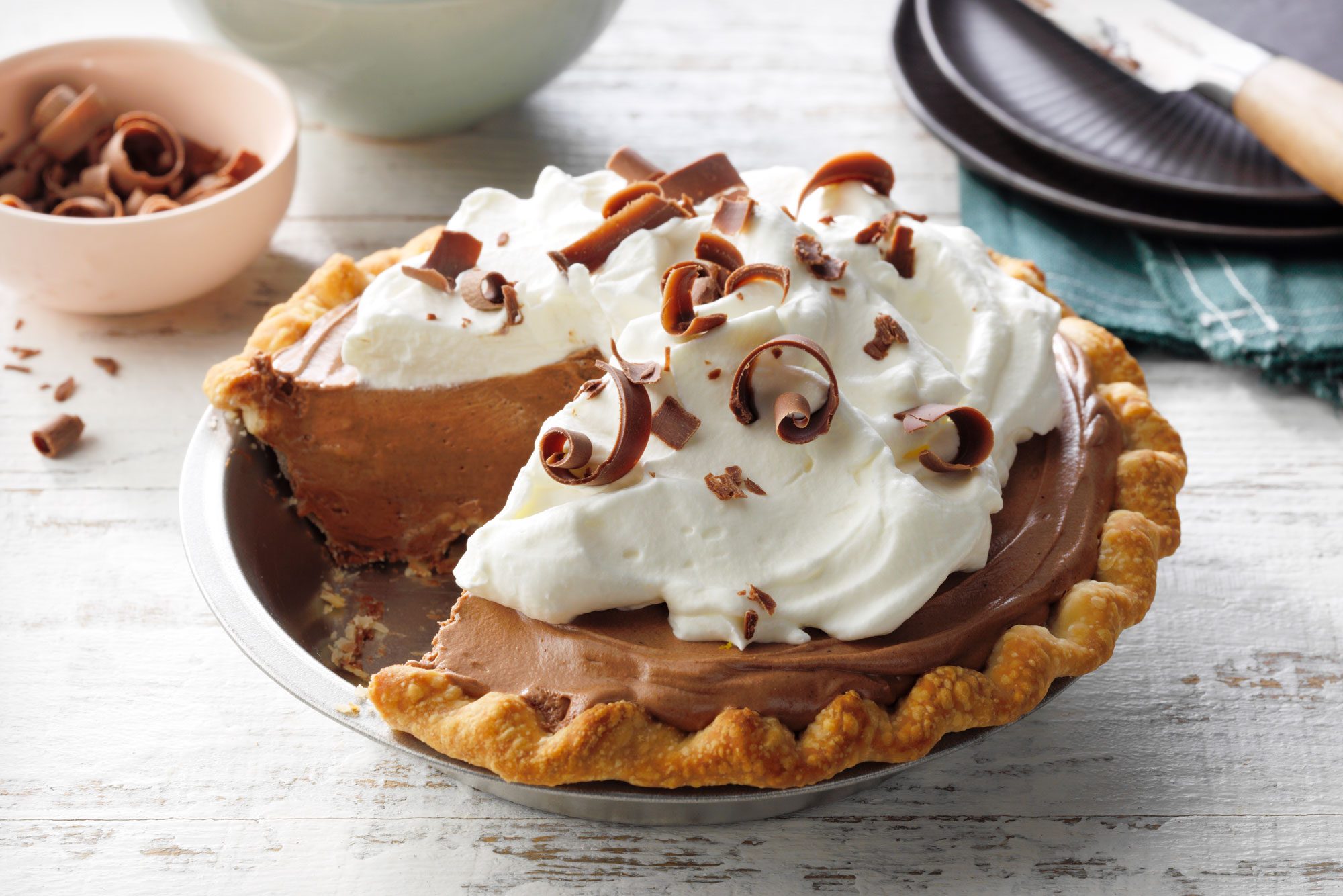 French Silk Pie in a steel pie plate on white painted wooden surface