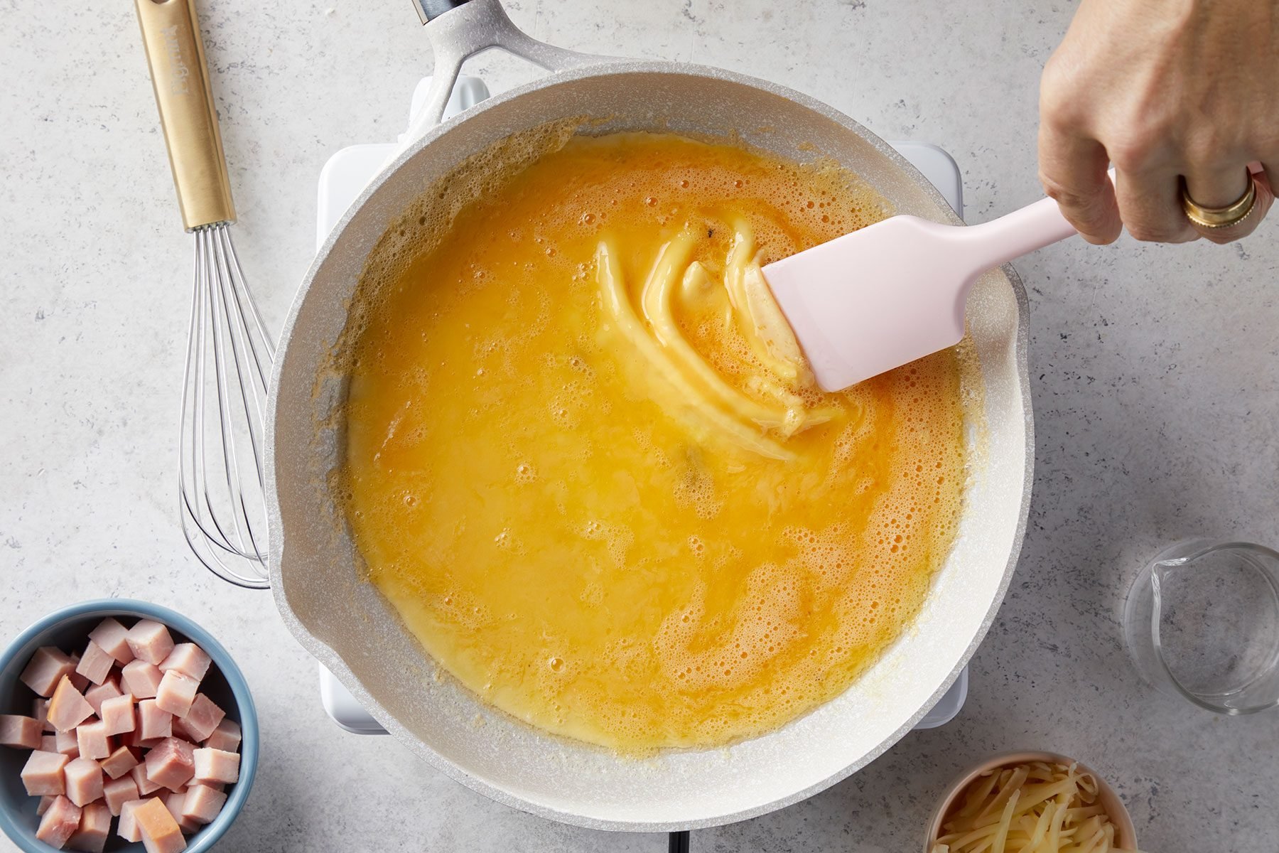 Shifting the cooked omelet edges to the center using spatula