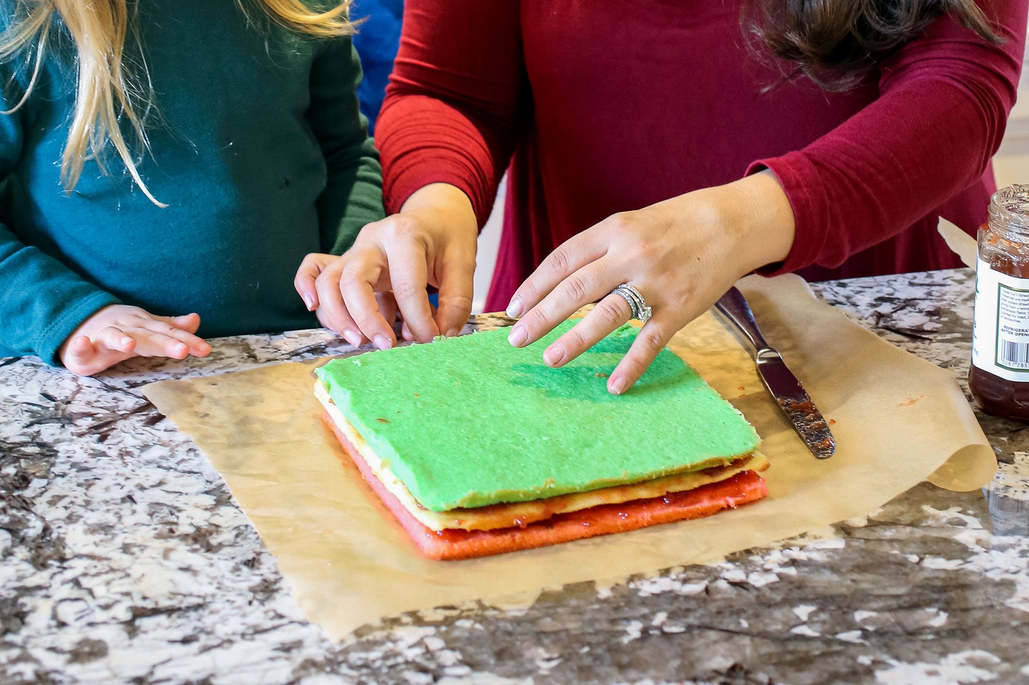 Hands and Colorful Breads on a Marble Kitchen Top