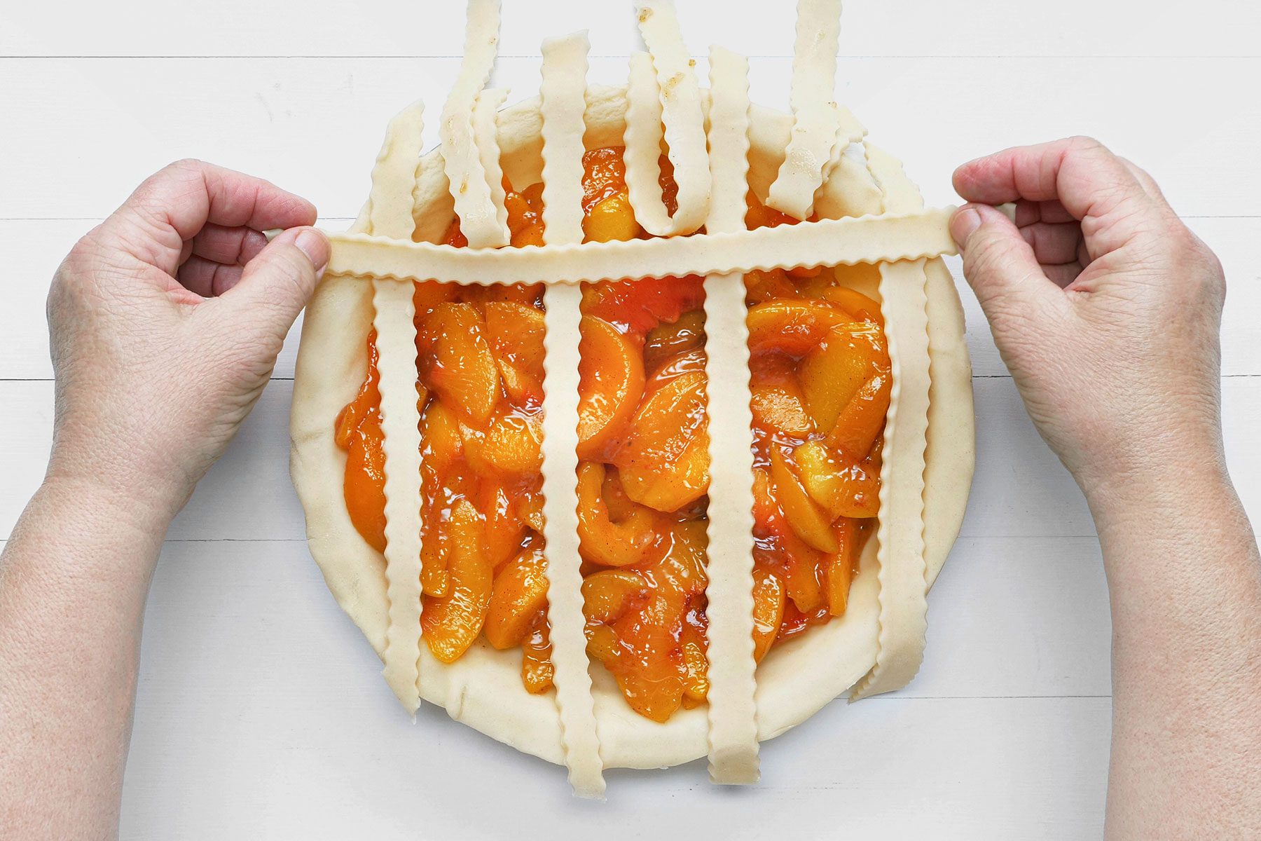 Setting dough strips on pie