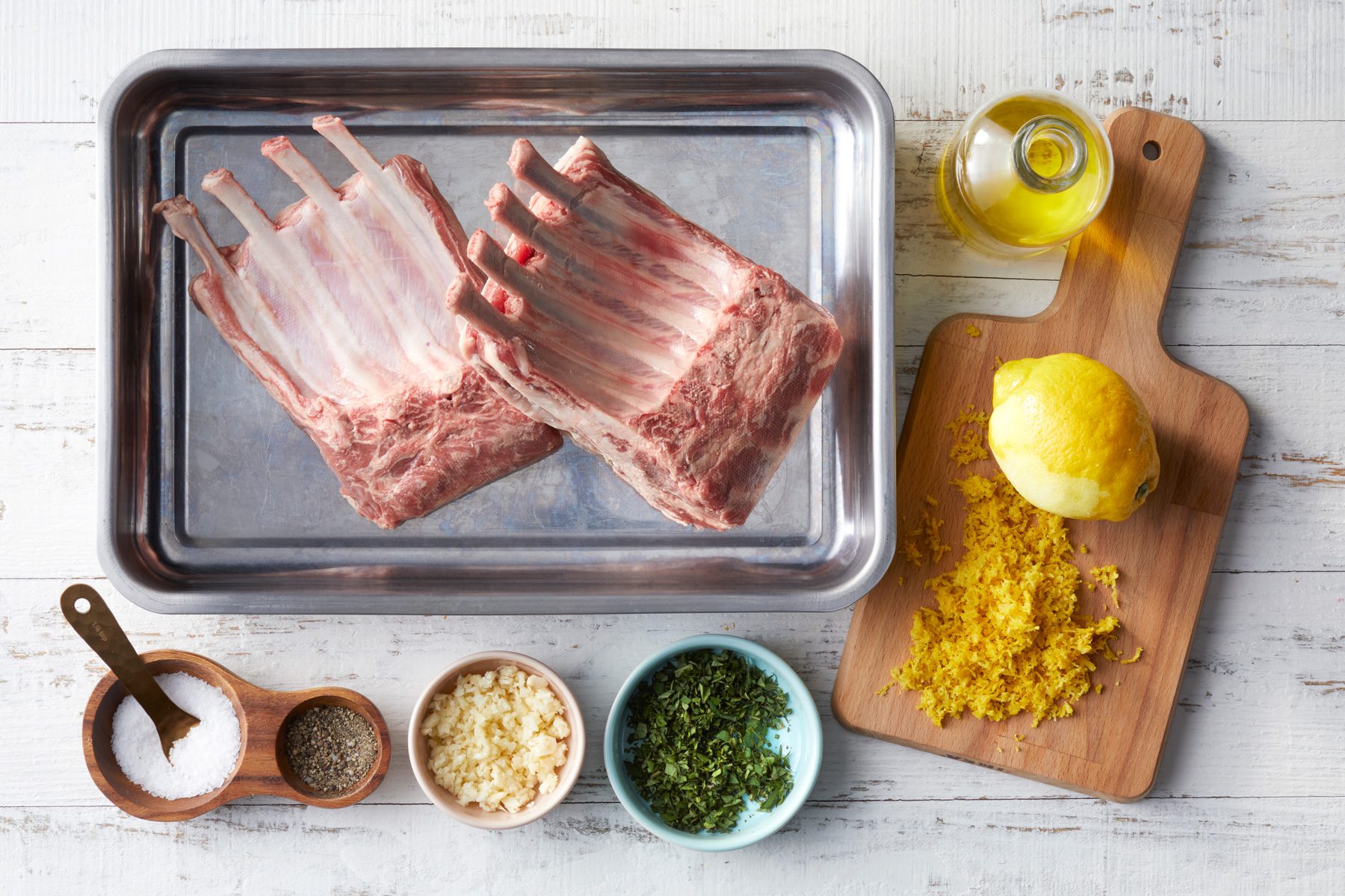 A tray of raw meat with spices and herbs