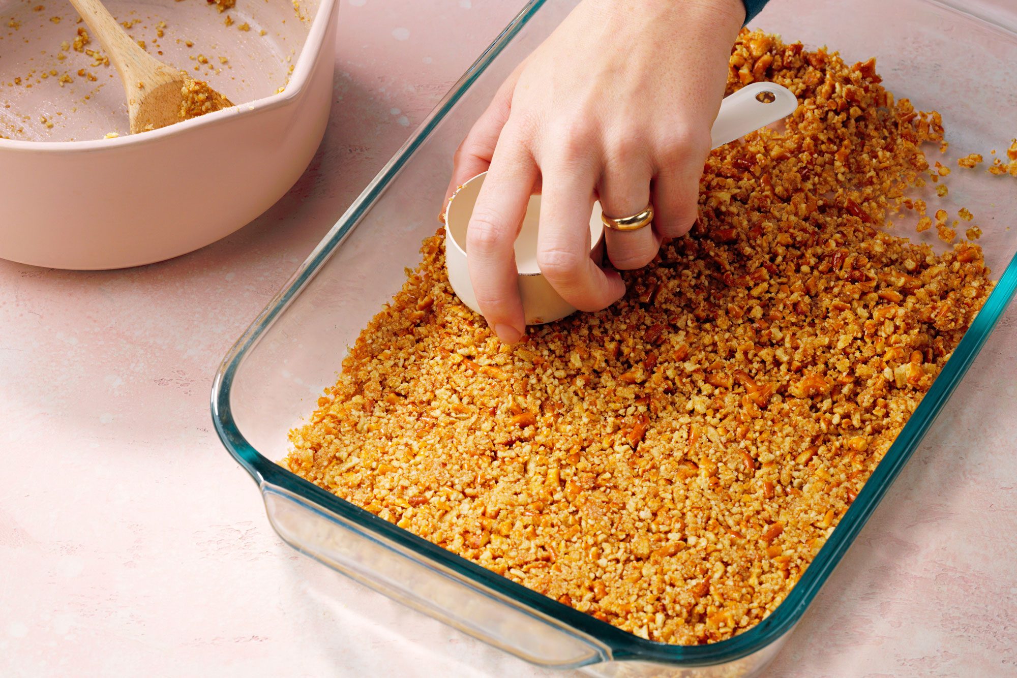 Combine the crushed pretzels, butter and sugar in a bowl