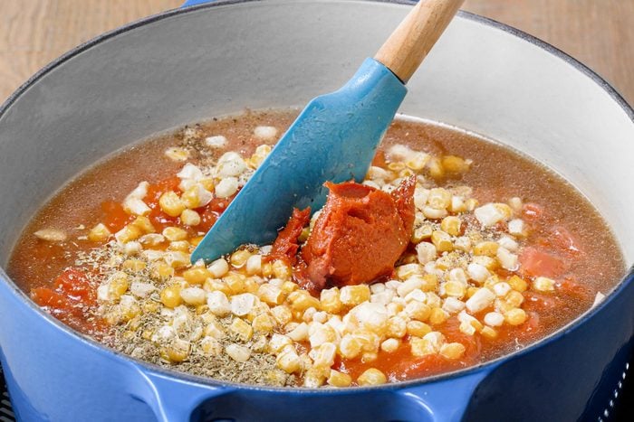 adding rest of the ingredients to a large stock put with lasagna soup