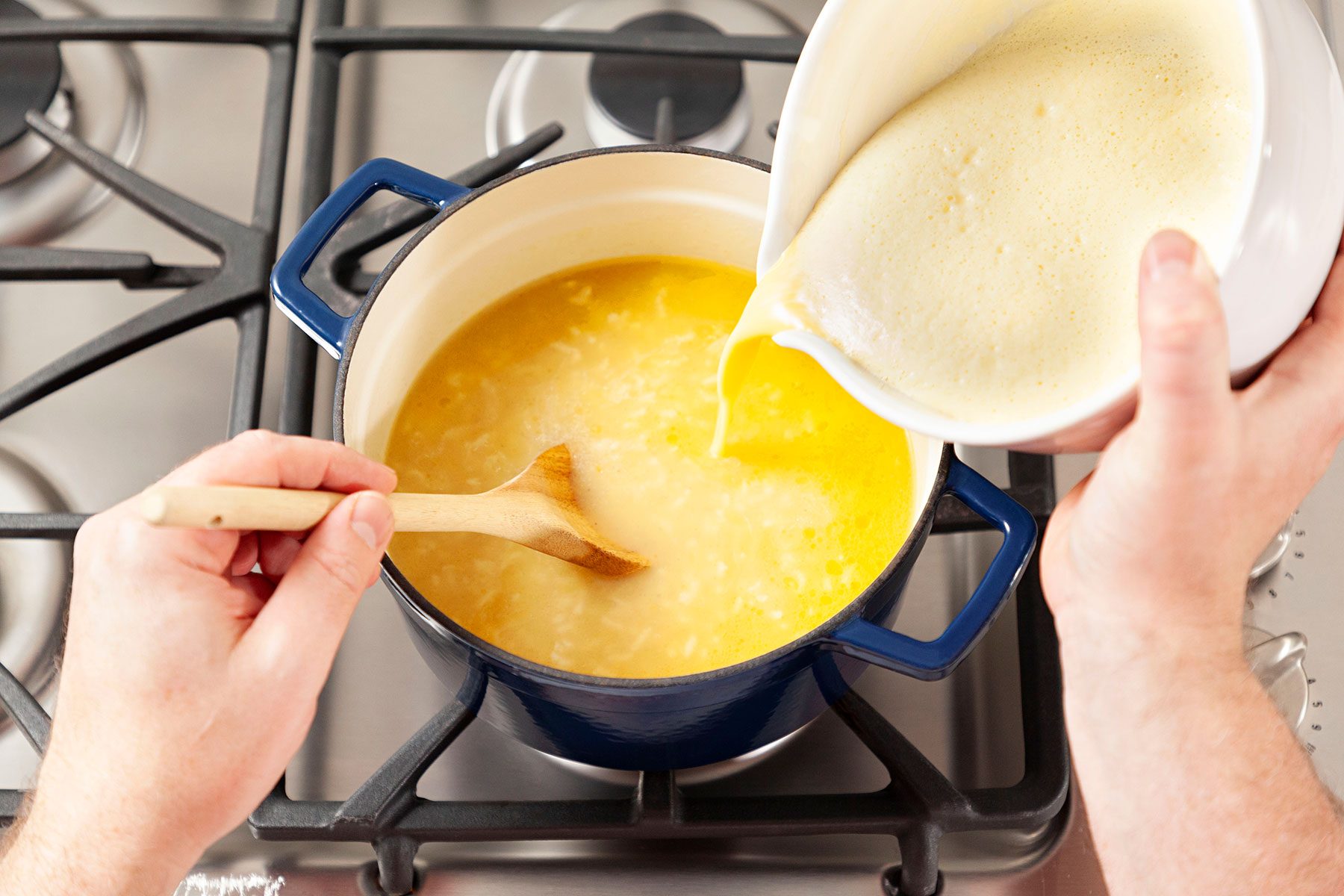 Adding the mixture in pot with rice