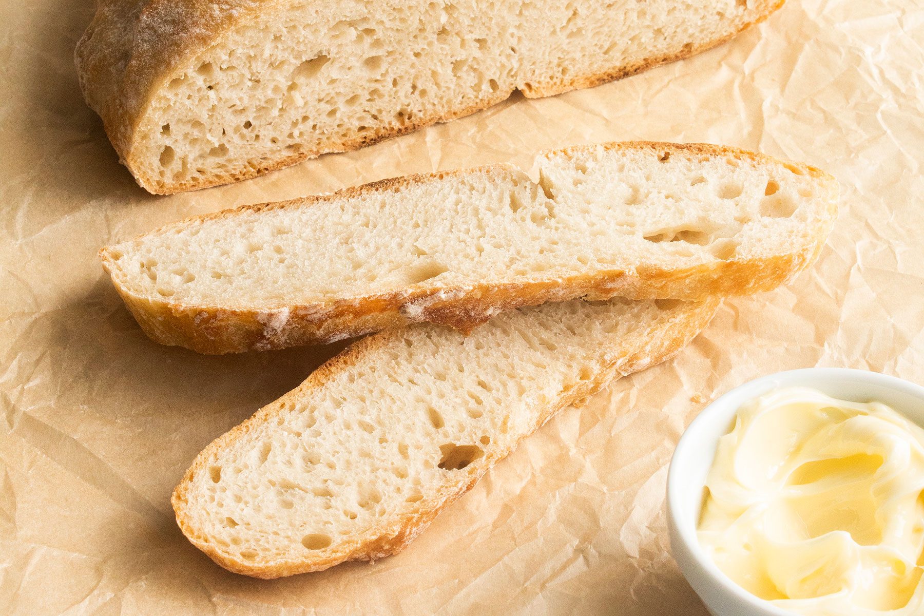Slices of Dutch Oven Bread with butter on the side