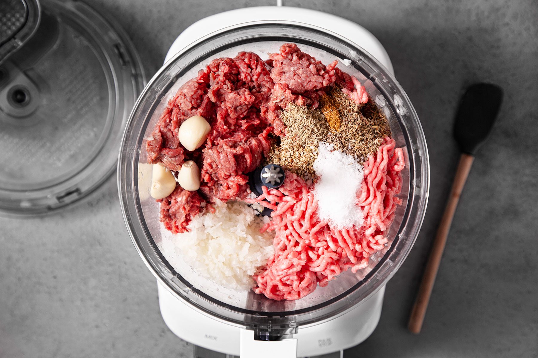 Pulsing meat, onions and other ingredients in mixer