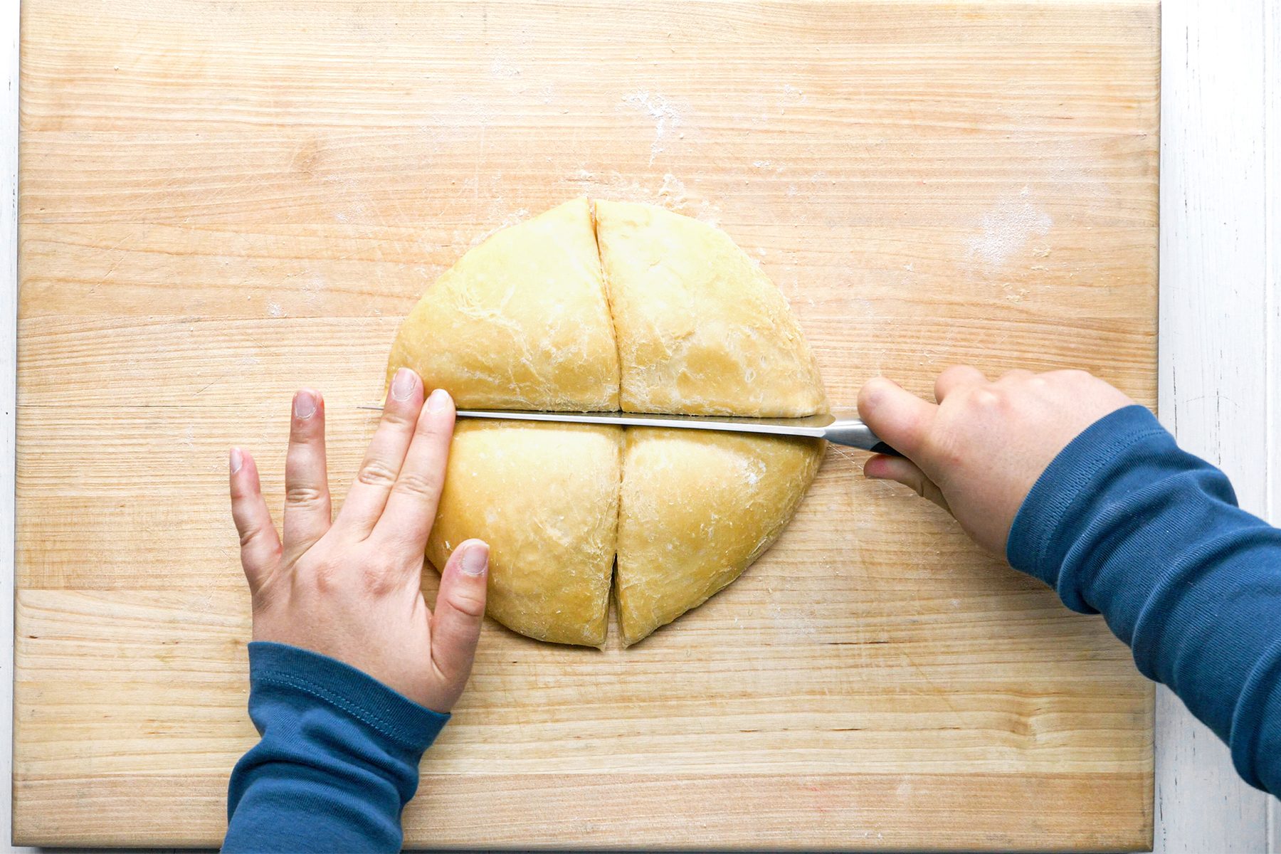 A person is Cutting Dough With Knife