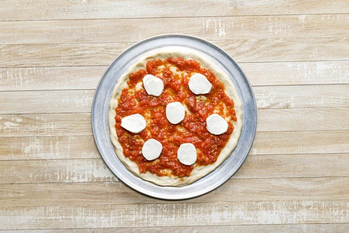 A margherita pizza on a pan