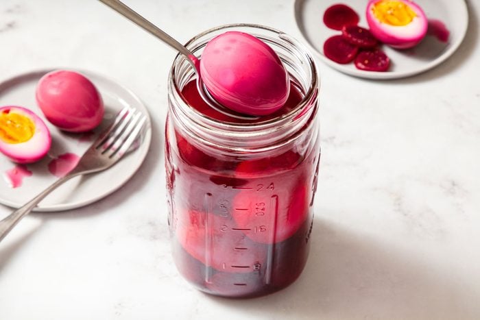Pickled Eggs And Beets in a Glass Jar on Marble Surface