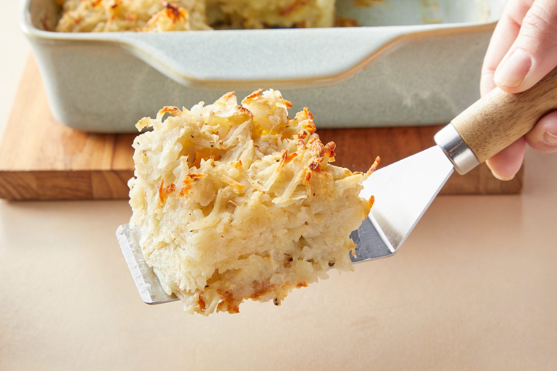 A piece of potato kugel on a spatula