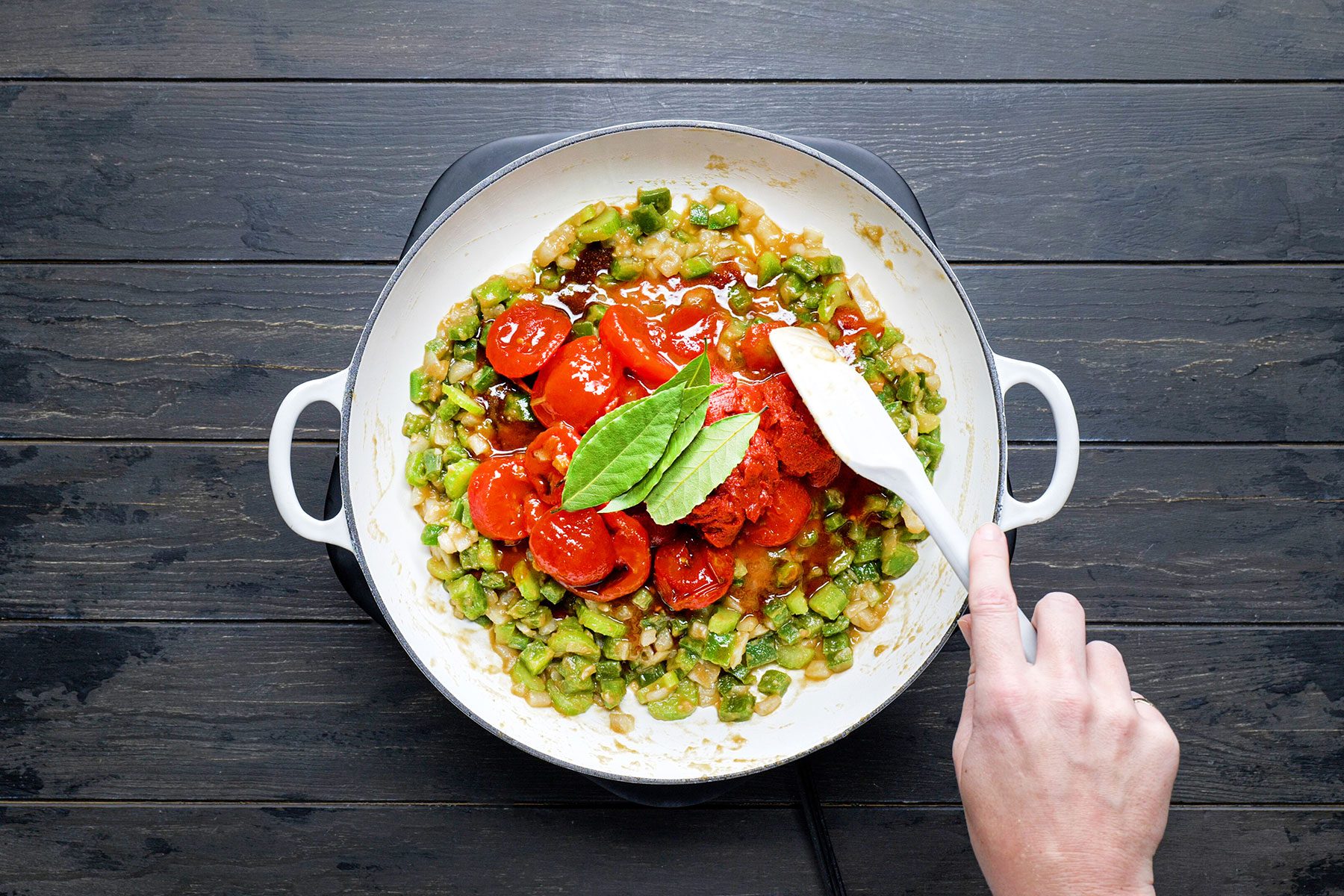 Stirring stewed tomatoes in the mixture