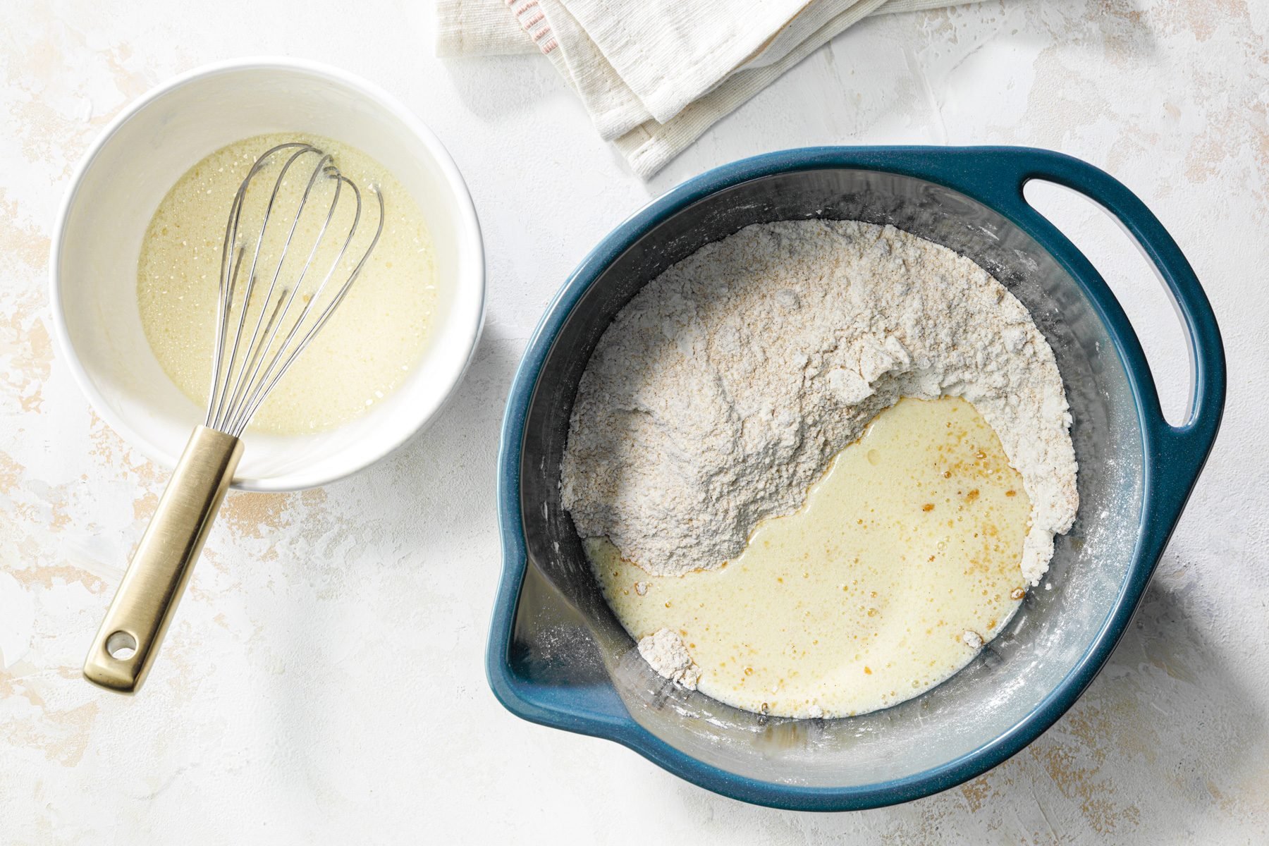 A bowl filled with wet and dry ingredients