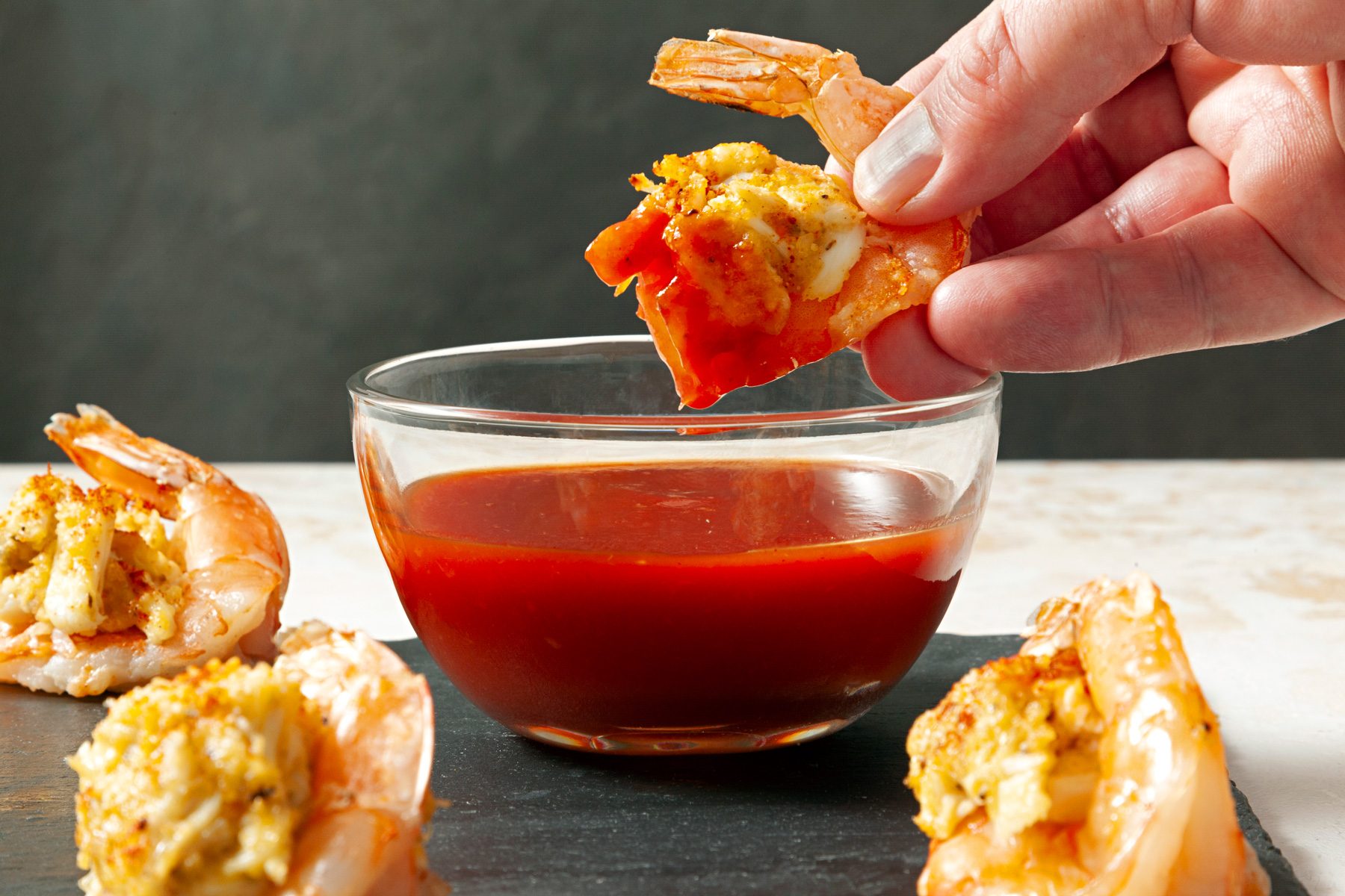 Stuffed Shrimp Appetizers dipped in sauce